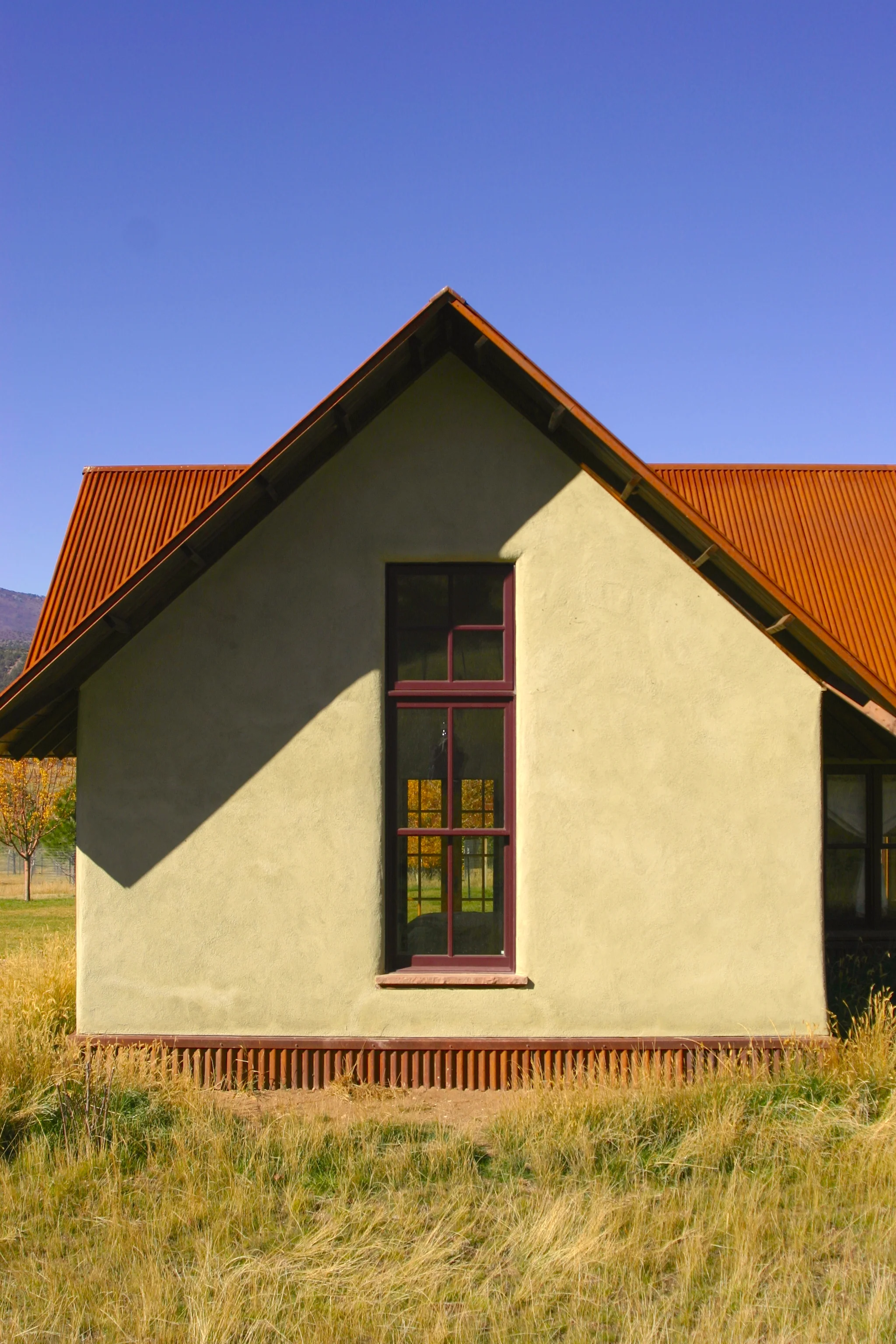 The straw-bale construction, combined with careful detailing, contributes both style and sustainability to the project