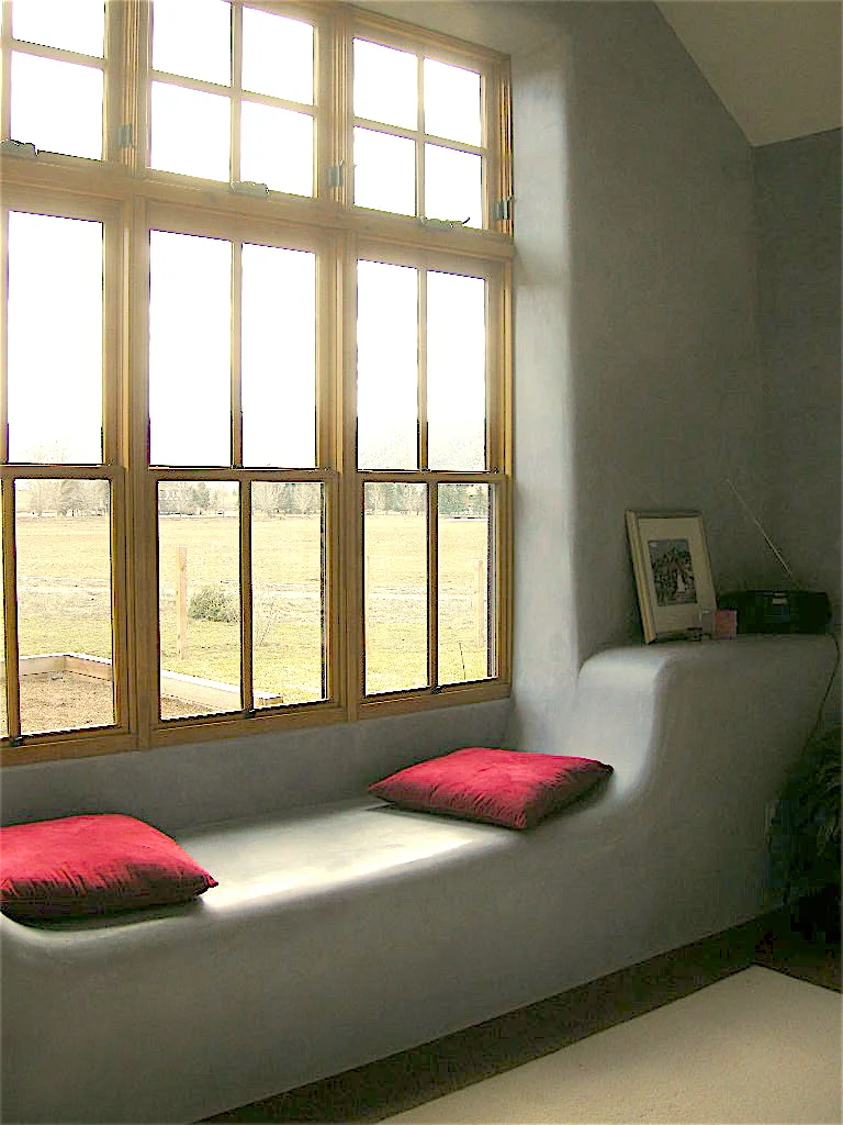 The thick straw-bale walls provide opportunities for details like this window seat in the master bedroom