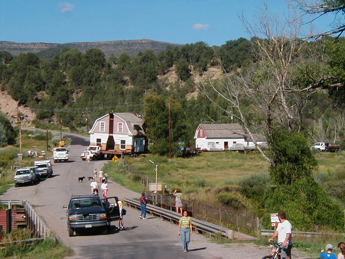 The yet-to-be-renovated house and barn beginning their 12-mile move from their original location