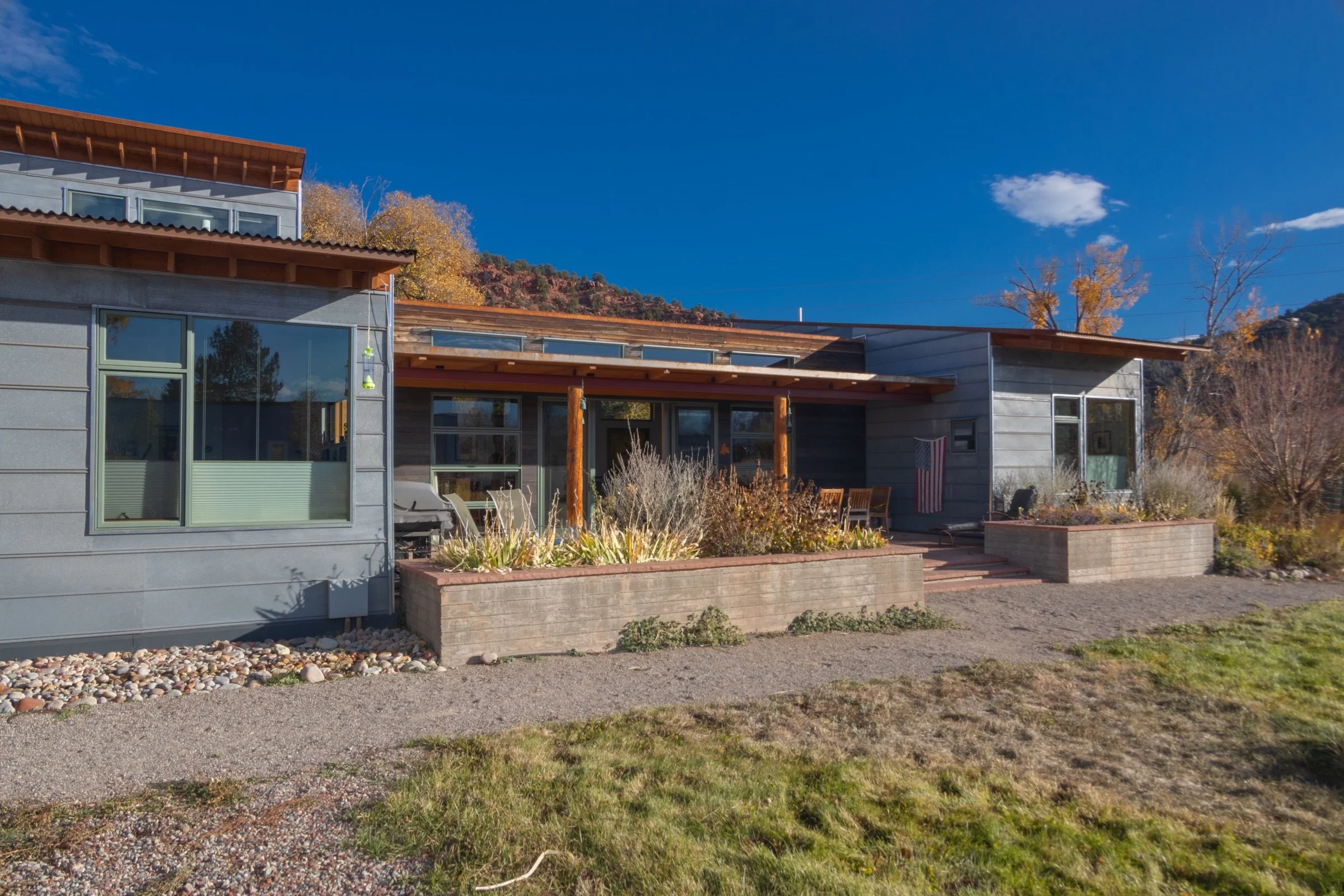 The main living space embraces a patio that opens up to winter sun, Sopris views, and the spacious yard, which doubles as a disc golf practice pitch. Board-formed planters contain a slightly raised terrace and bring plants to where one can enjoy the