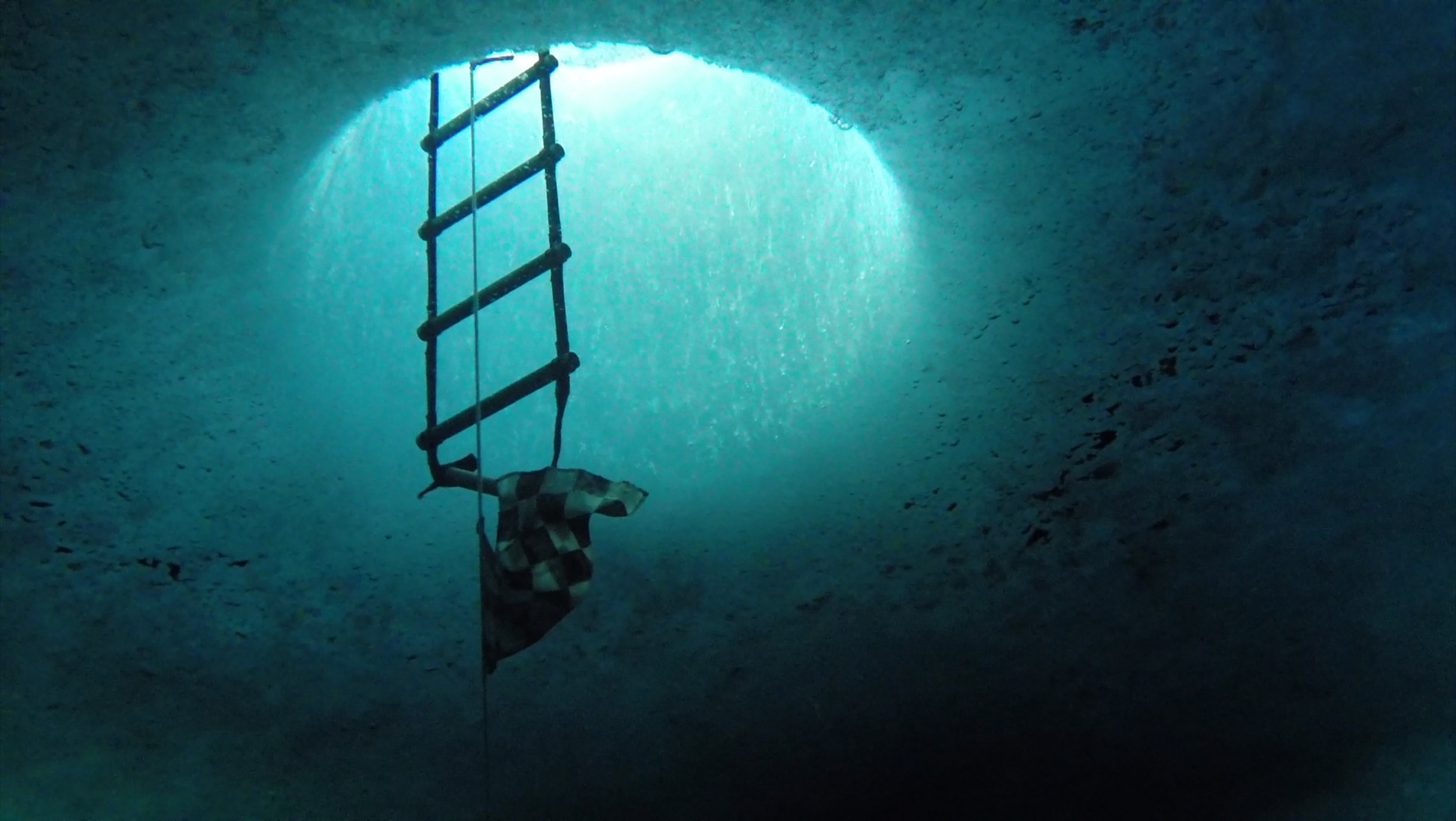  Dive hole from under the ice. The ice around McMurdo Station is approximately 6 ft thick and must be drilled through with a giant ice auger. 