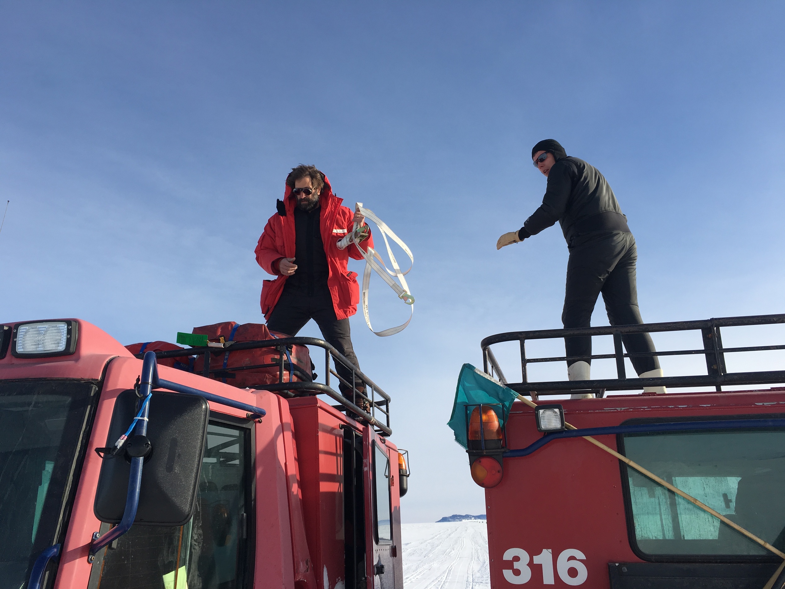  Steve and Bret transfer survival bags from one pisten bully to another out on the ice. 