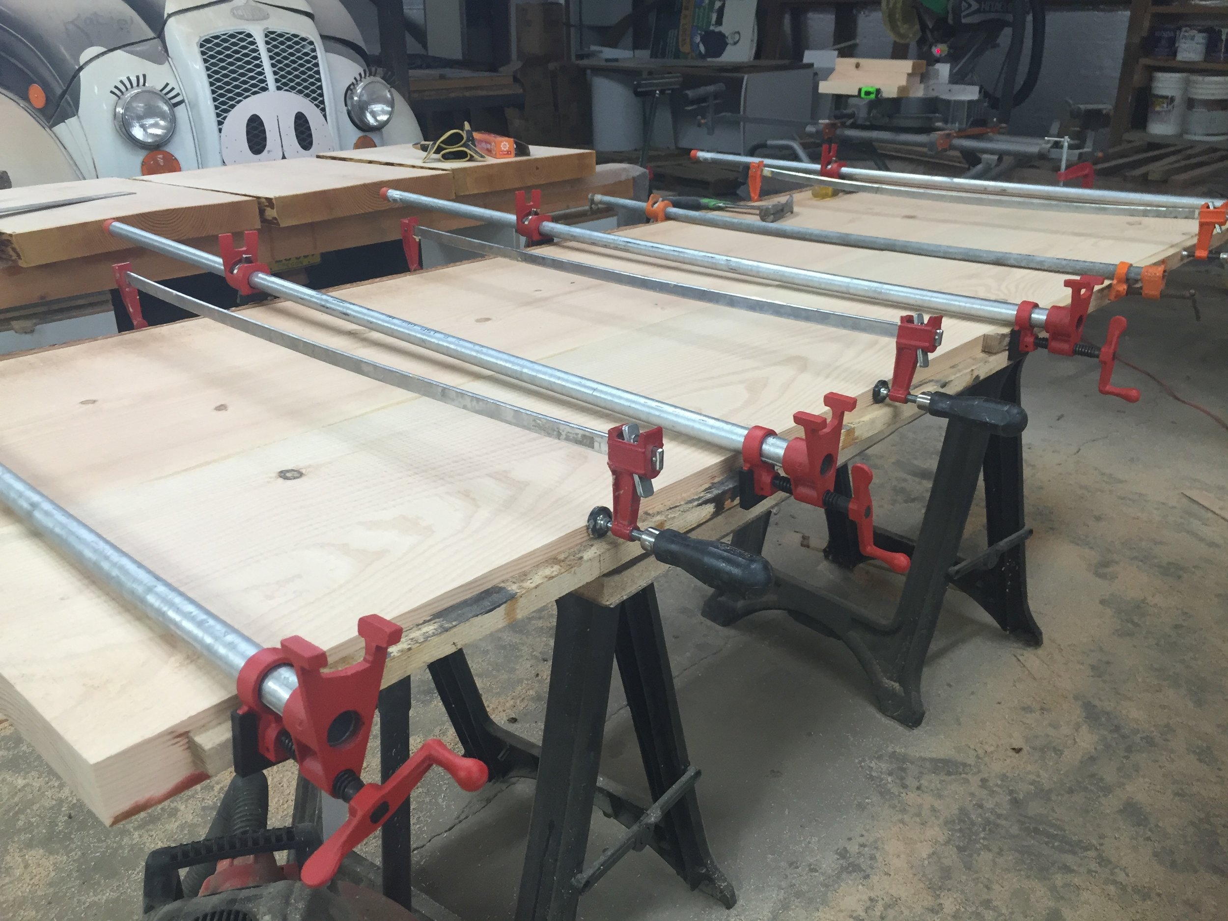  After we joint the slabs, we glued two of them together to get the full width we were going for. We bought some heavy-duty clamps and crossed our fingers that everything would work out right. 