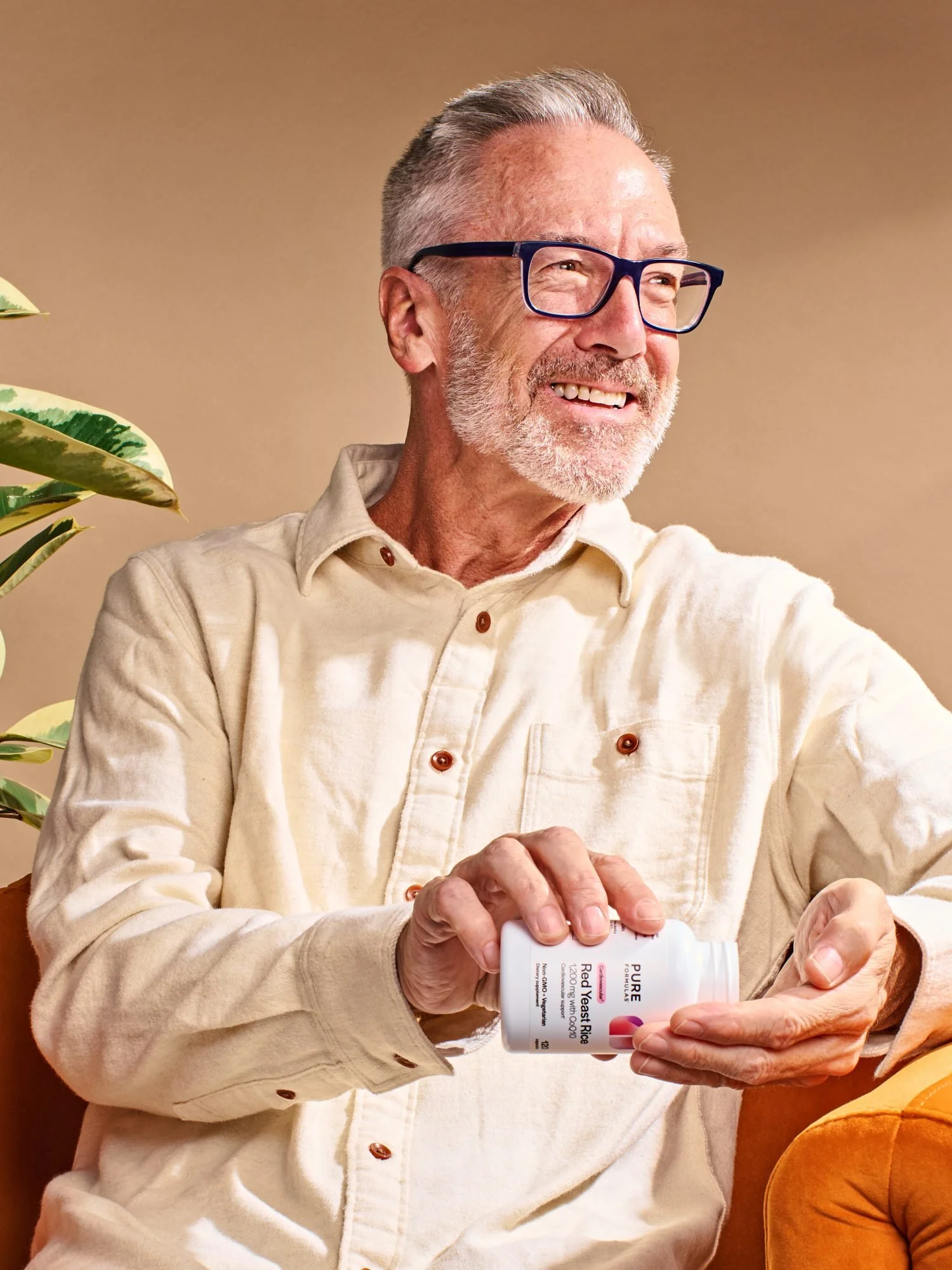 Commercial photography of a man sitting in a chair and taking supplments