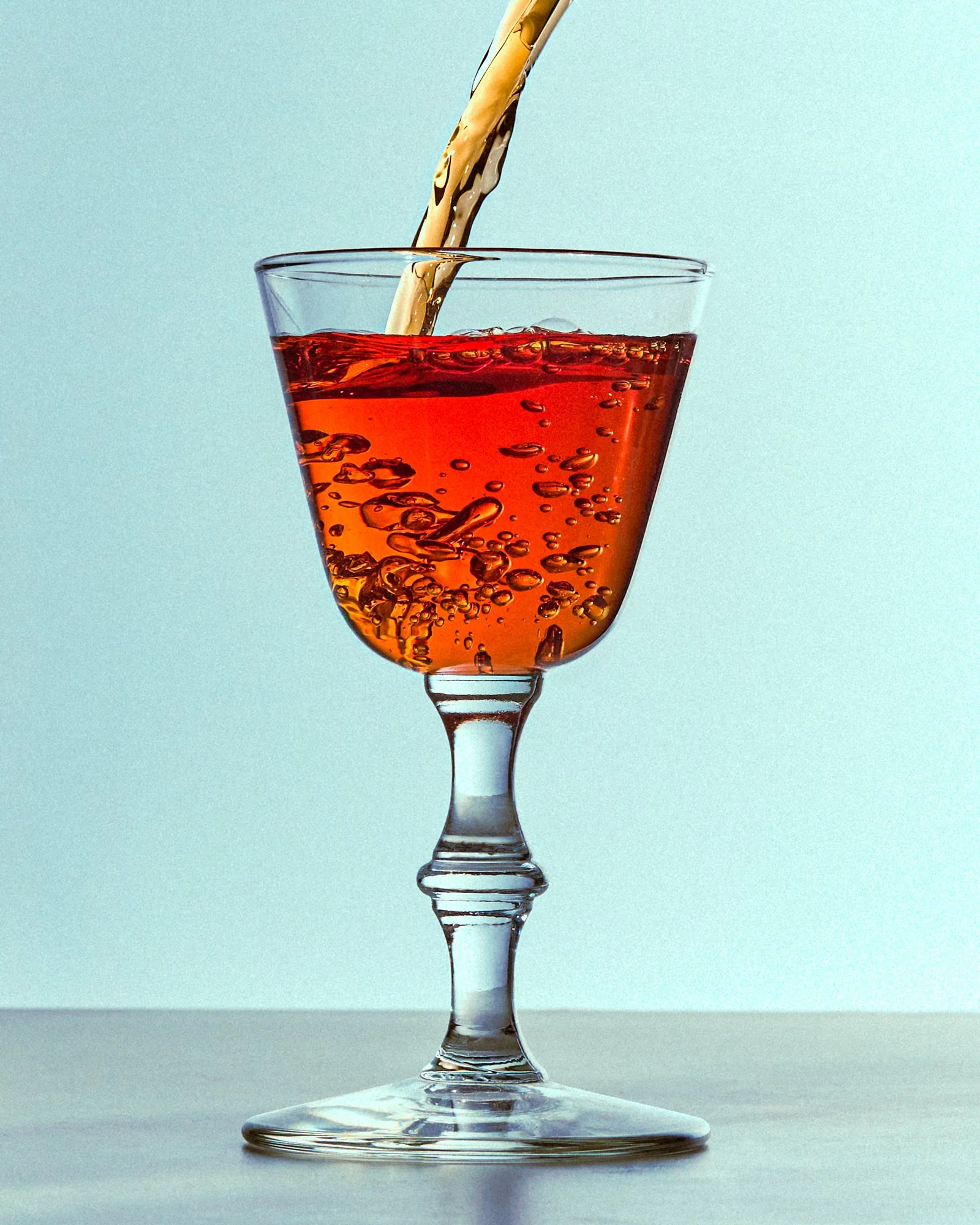 Commercial photography of a glass of fortified wine being poured / shot by food and beverage photographer Ali Redmond