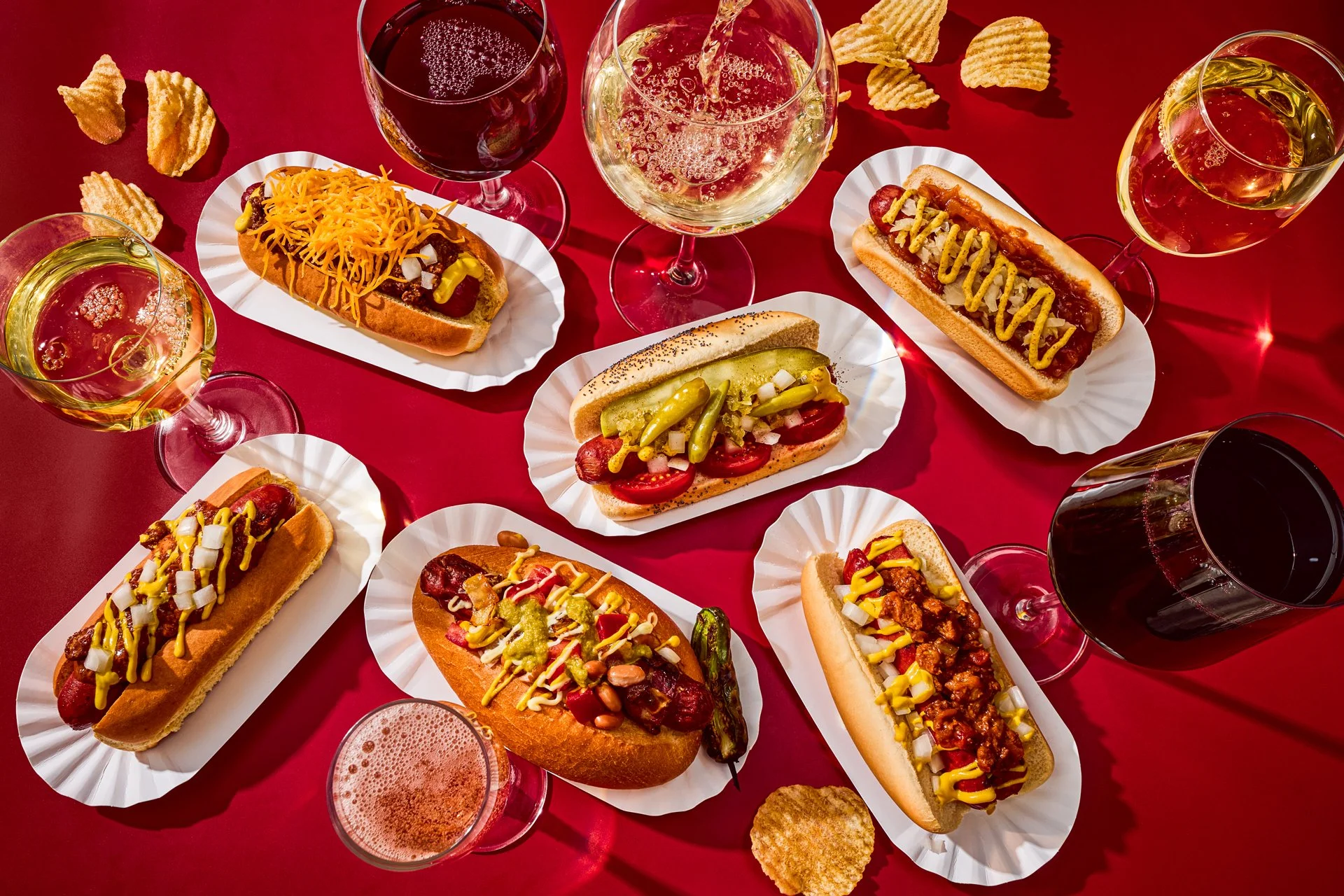 editorial food photo of a collection of regional hot dogs paired with various glasses of wine / shot by commercial food photographer Ali Redmond