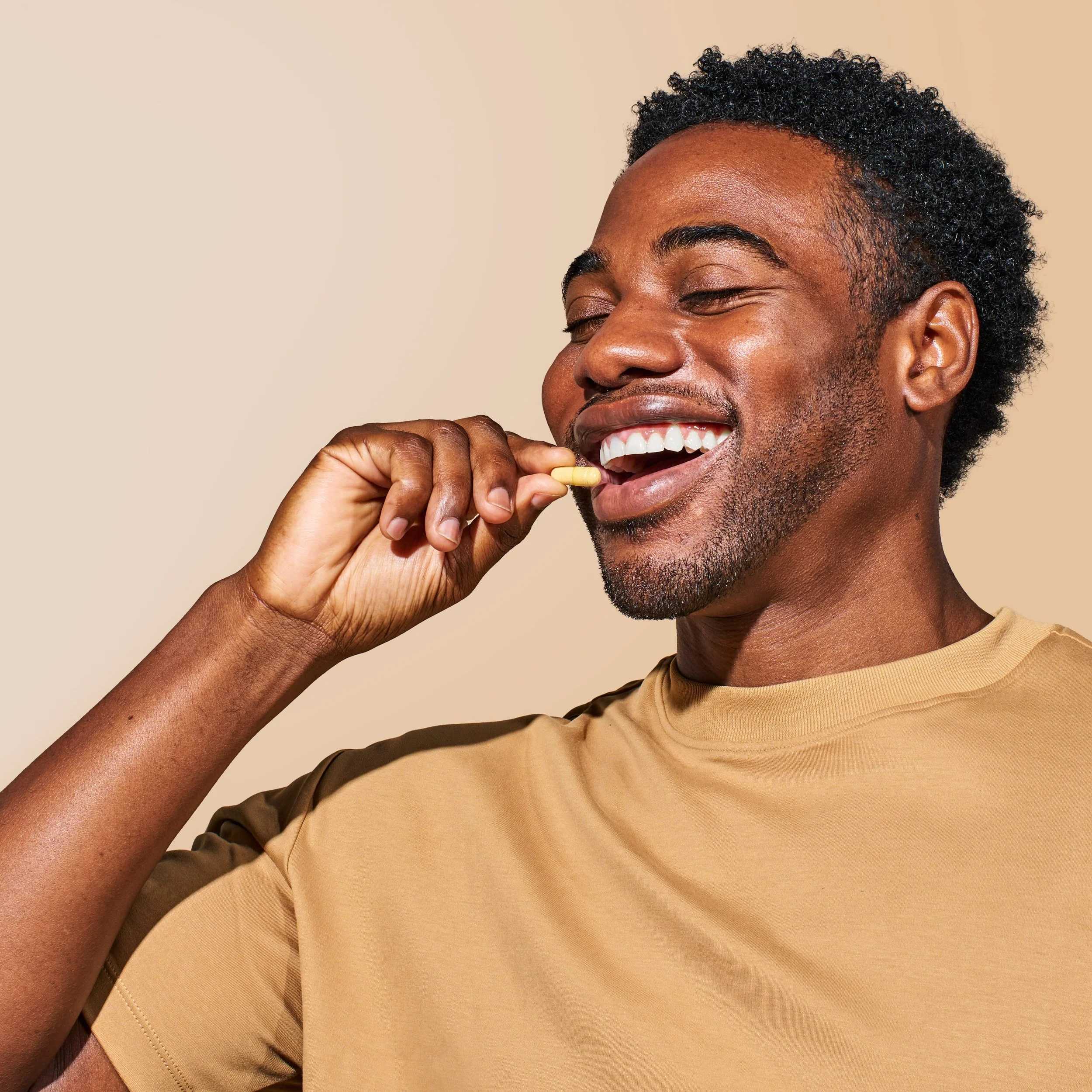 Commercial photography of a man taking a supplement