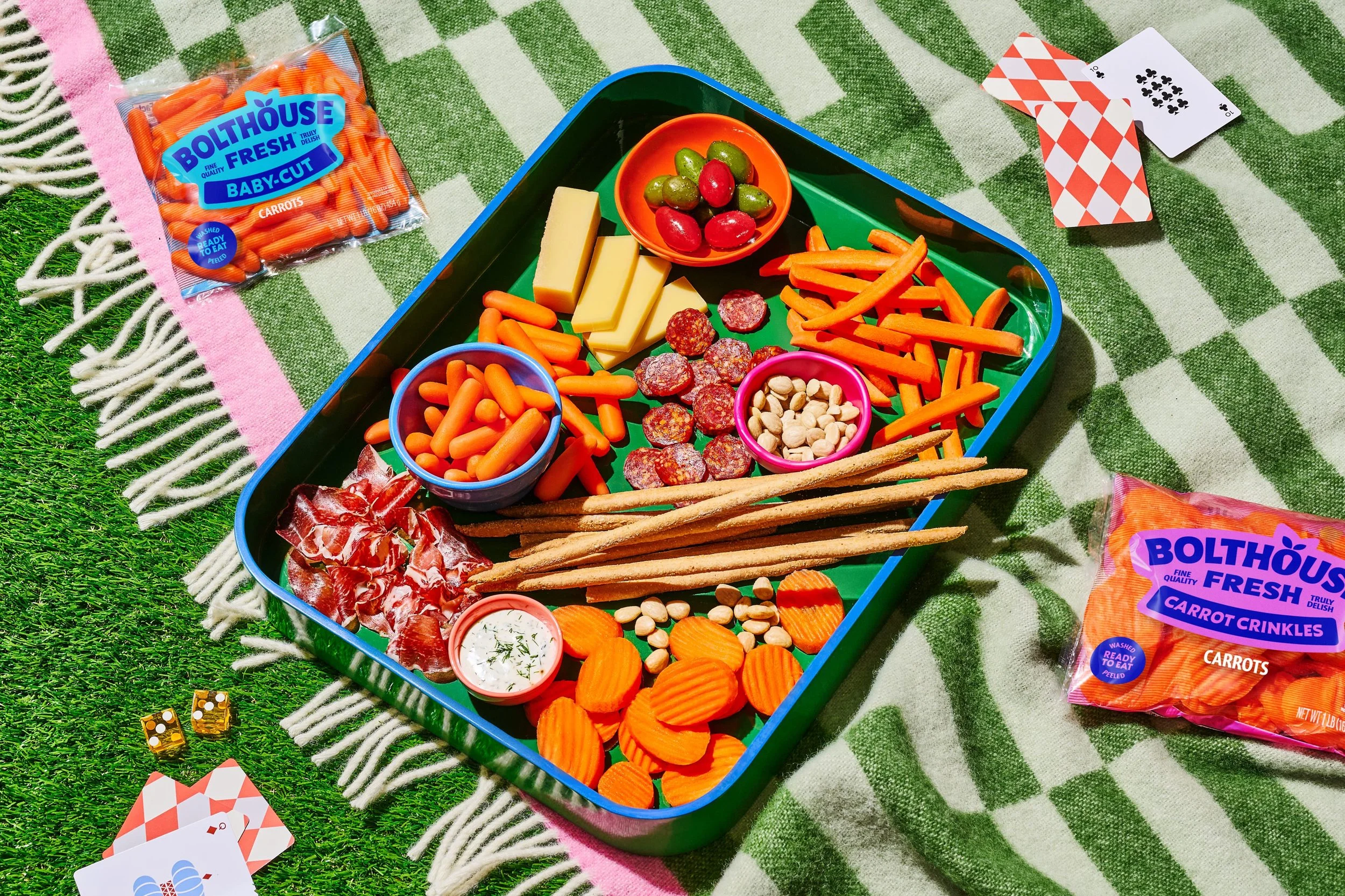 Commercial photography of a picnic scene with a charcuterie board and games