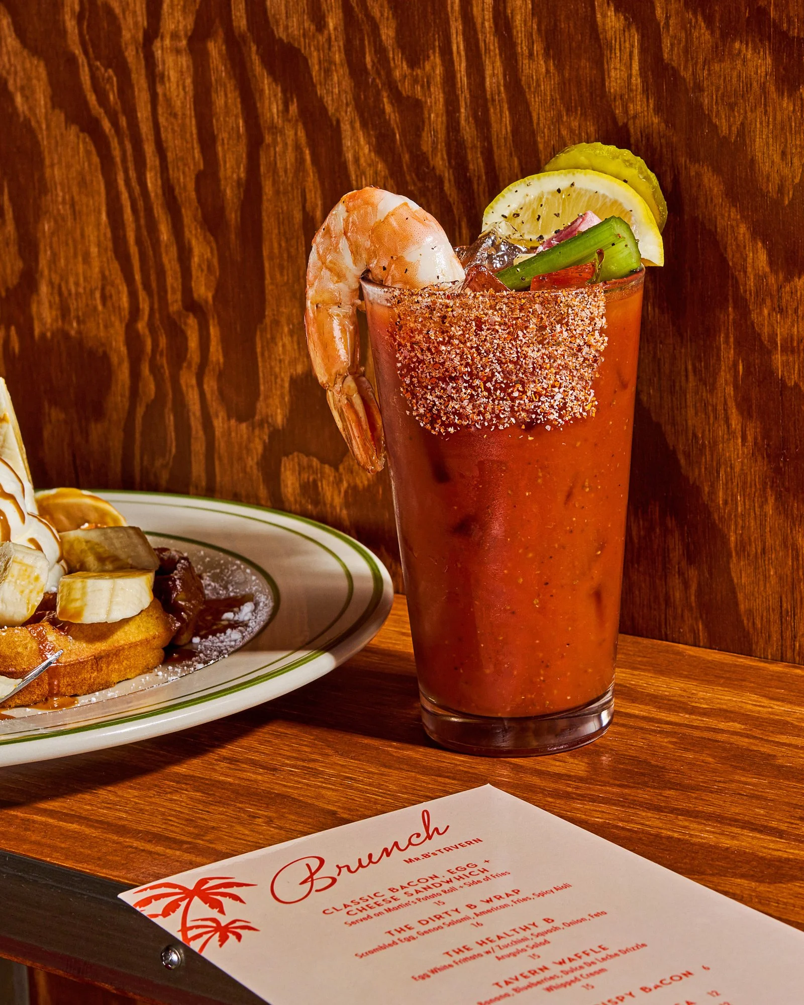 restaurant beverage photo of a bloody mary with waffles and a menu / shot by commercial food photographer Ali Redmond