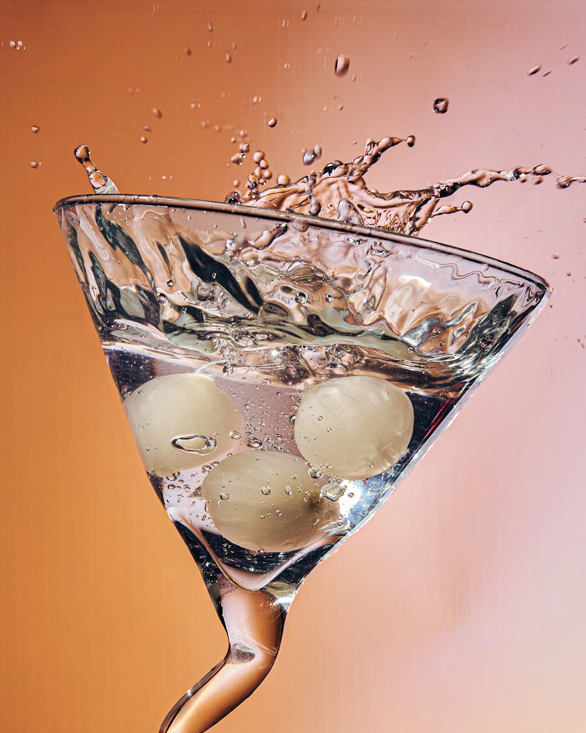 Commercial beverage photography of a splash cocktail with cocktail onions shot by food and beverage photographer Ali Redmond