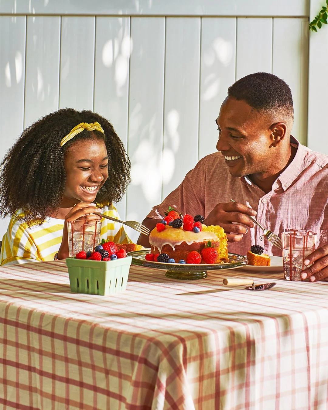 Commercial photography of a father and daughter having dessert outside 