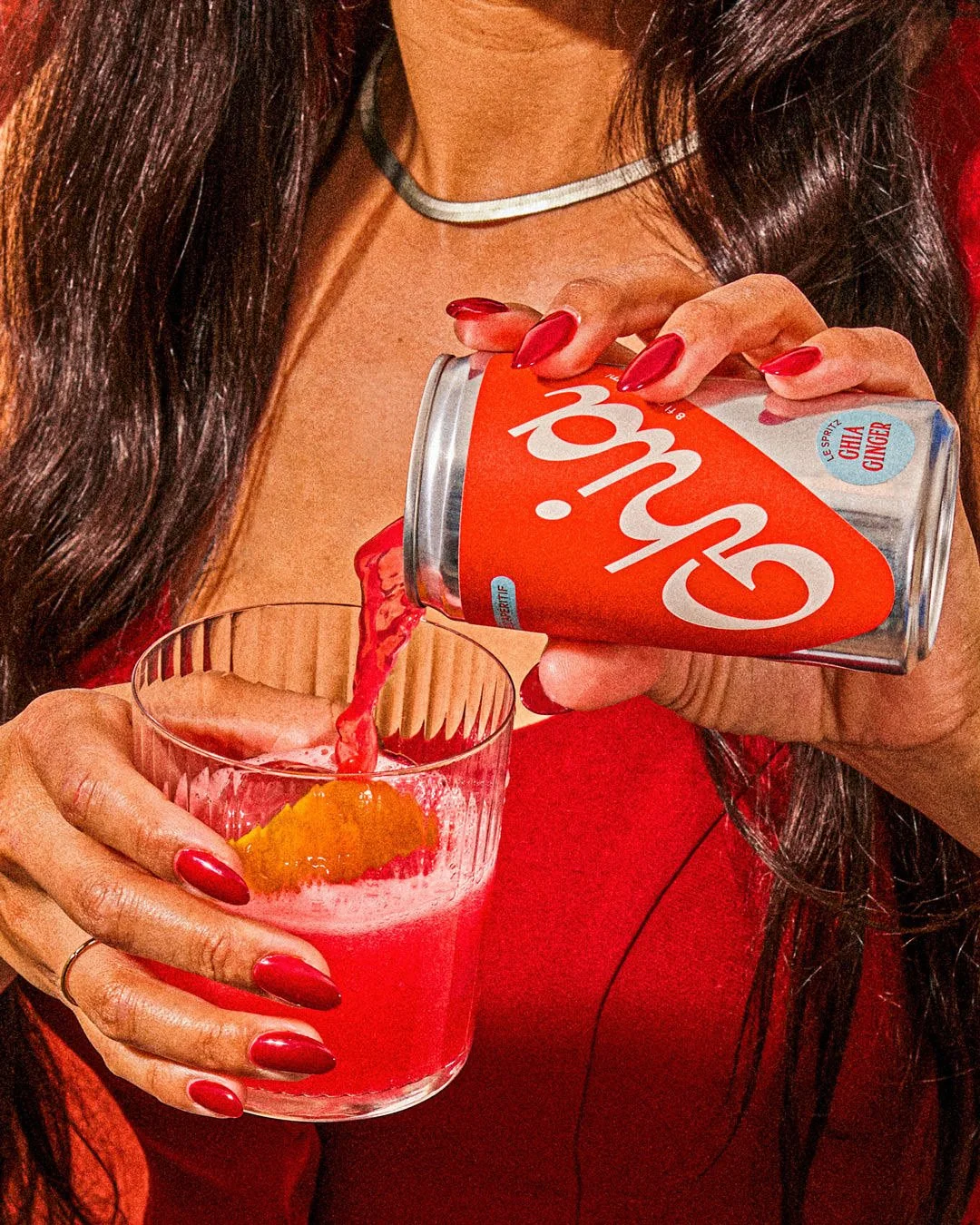 commercial brand beverage photo of a woman pouring a drink of canned non alcohol aperitif / shot by commercial food photographer Ali Redmond