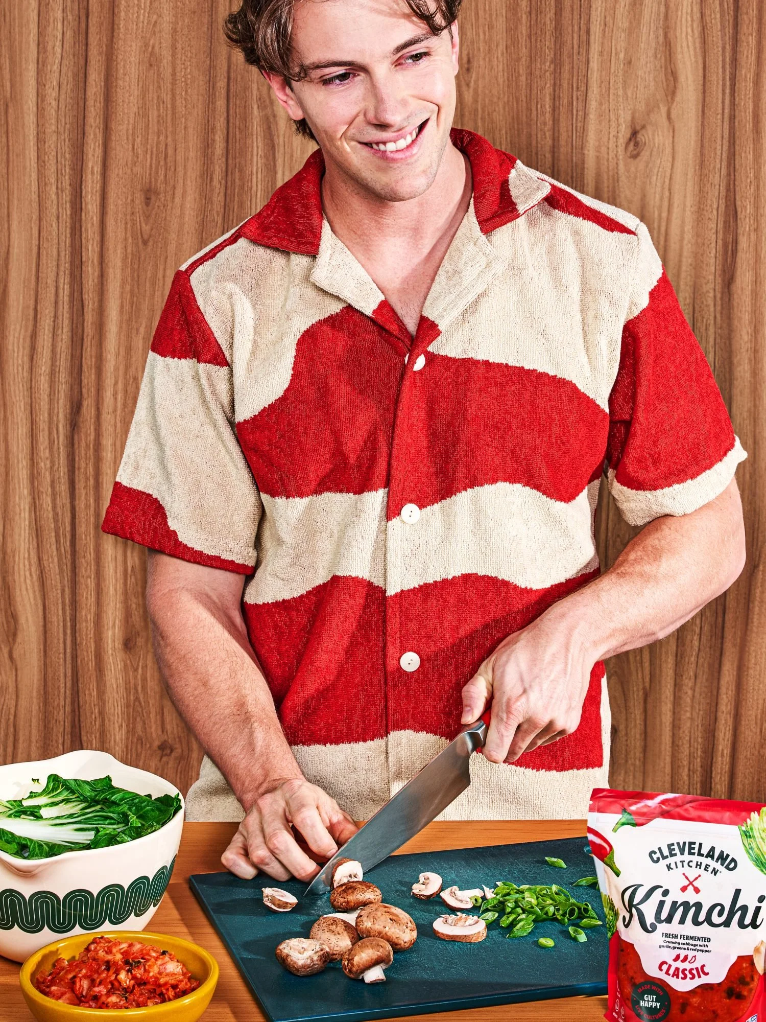 Commercial photography of a man chopping vegetables prepping for a meal