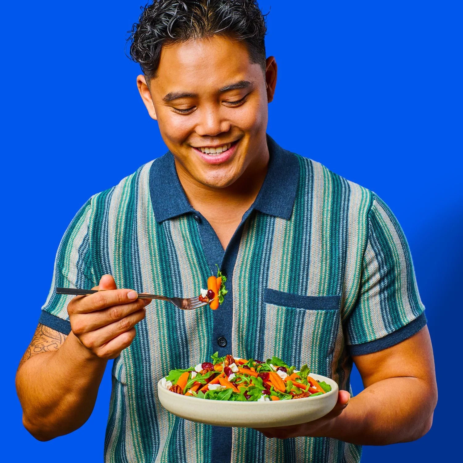 Commercial photography of a man eating a salad