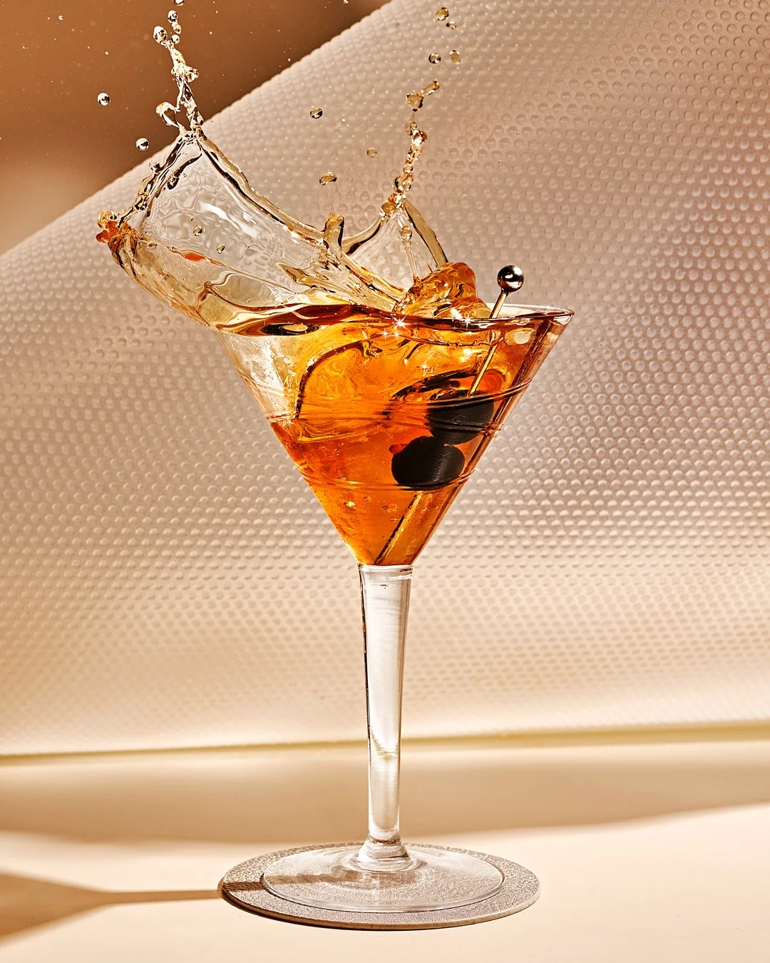 Commercial photography of a manhattan cocktail splash
