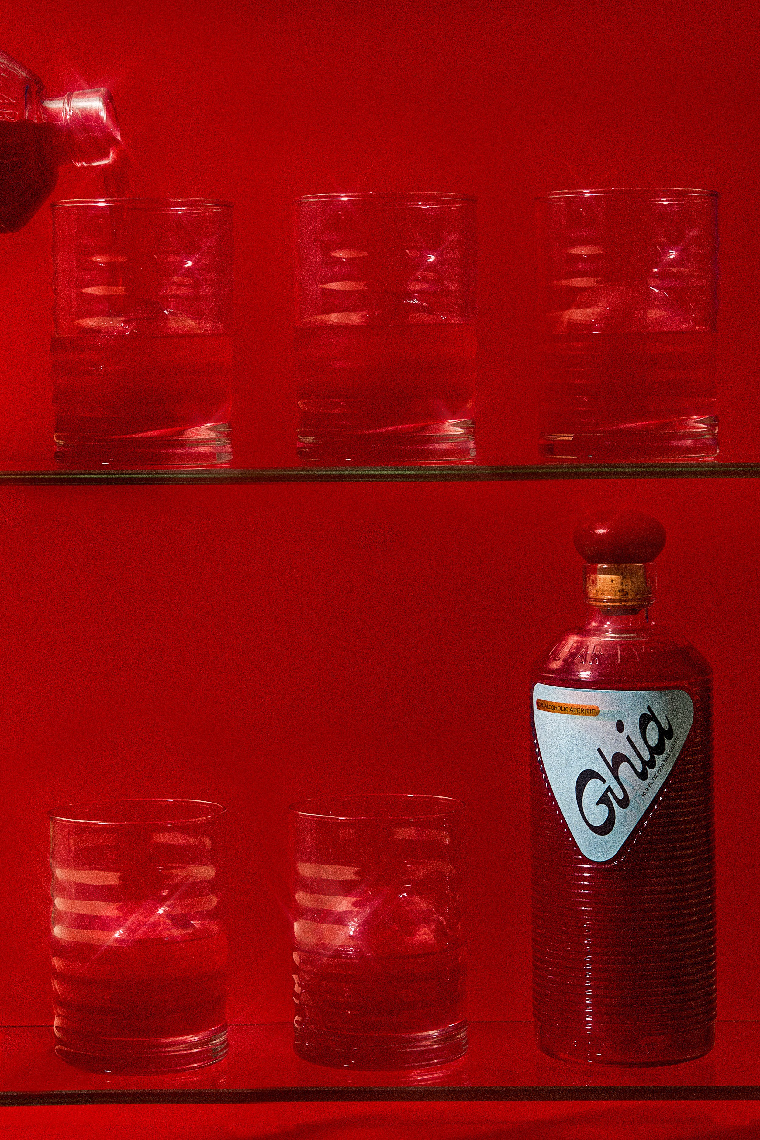 commercial brand beverage photo of a collection of glasses and a bottle / shot by commercial food photographer Ali Redmond