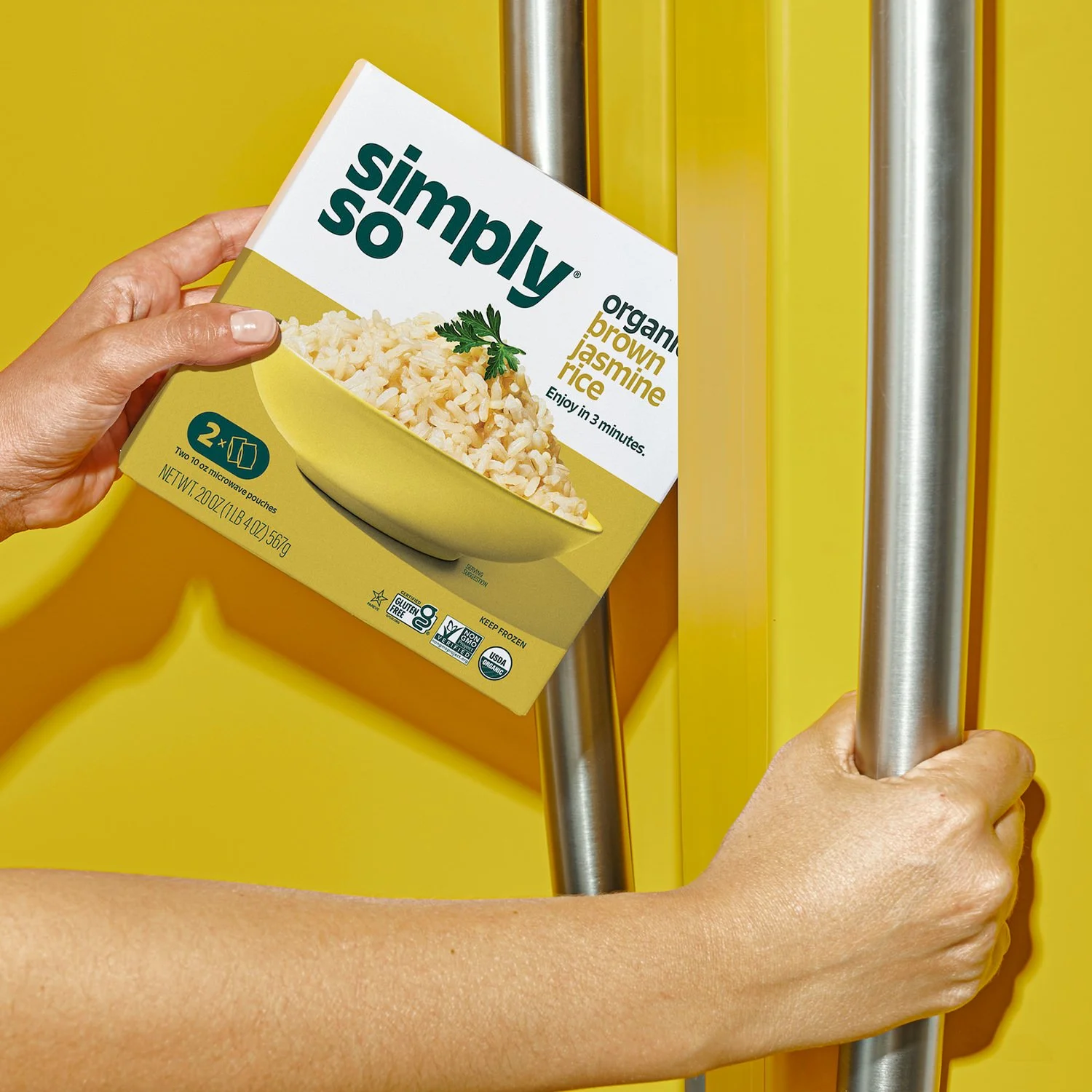 Commercial photography of a woman taking a frozen food product out of the freezer