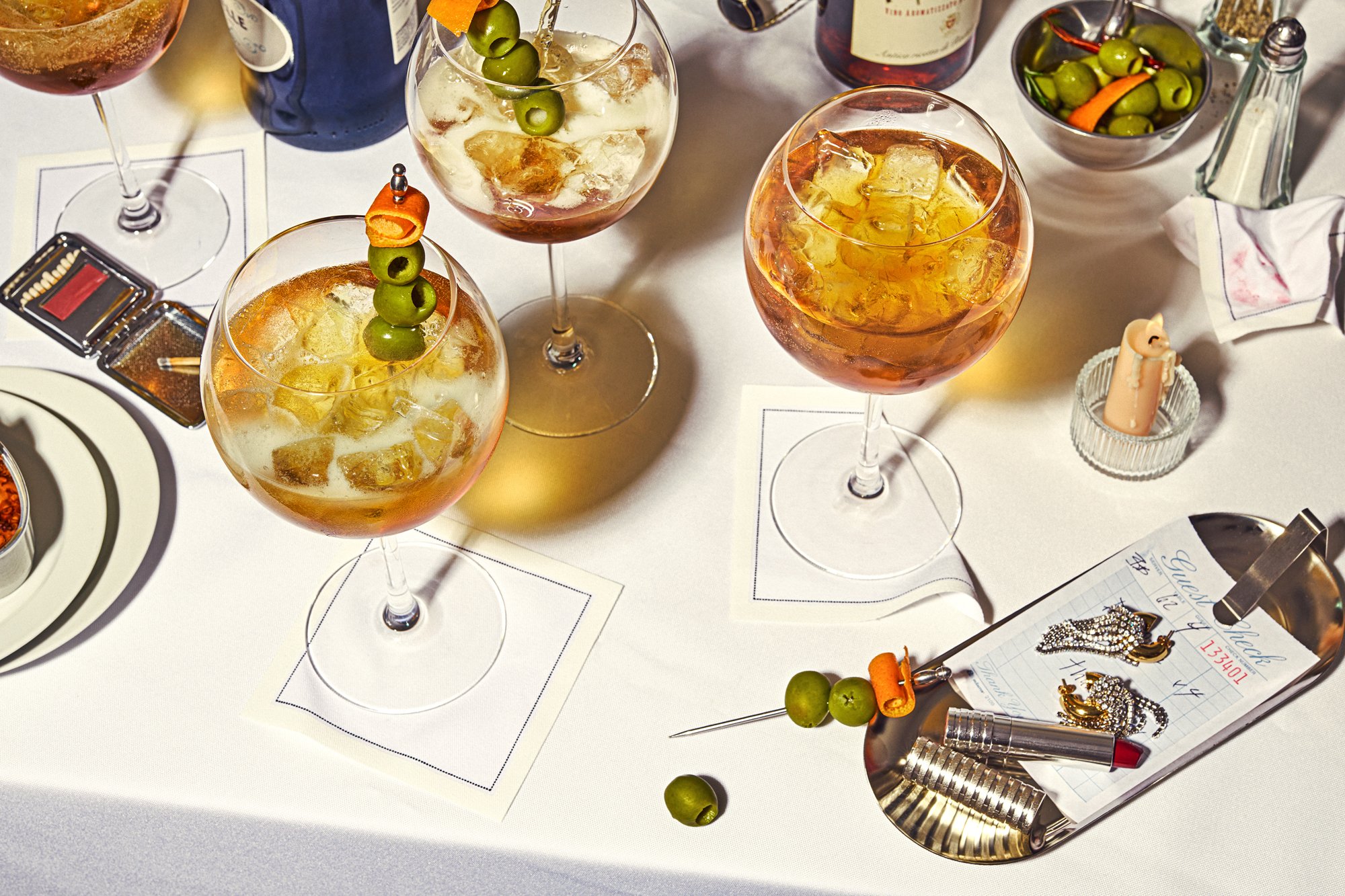 editorial beverage photo of a collection of cocktails at a late night dinner table / shot by commercial food photographer Ali Redmond