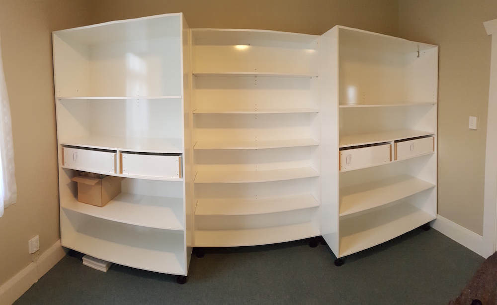 The cabinet with the hidden shelving before the pivot door is attached