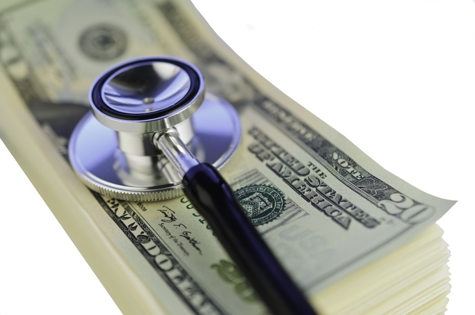Examination of financial condition Stethoscope on pile of U.S. twenty-dollar bills isolated on white background.jpeg