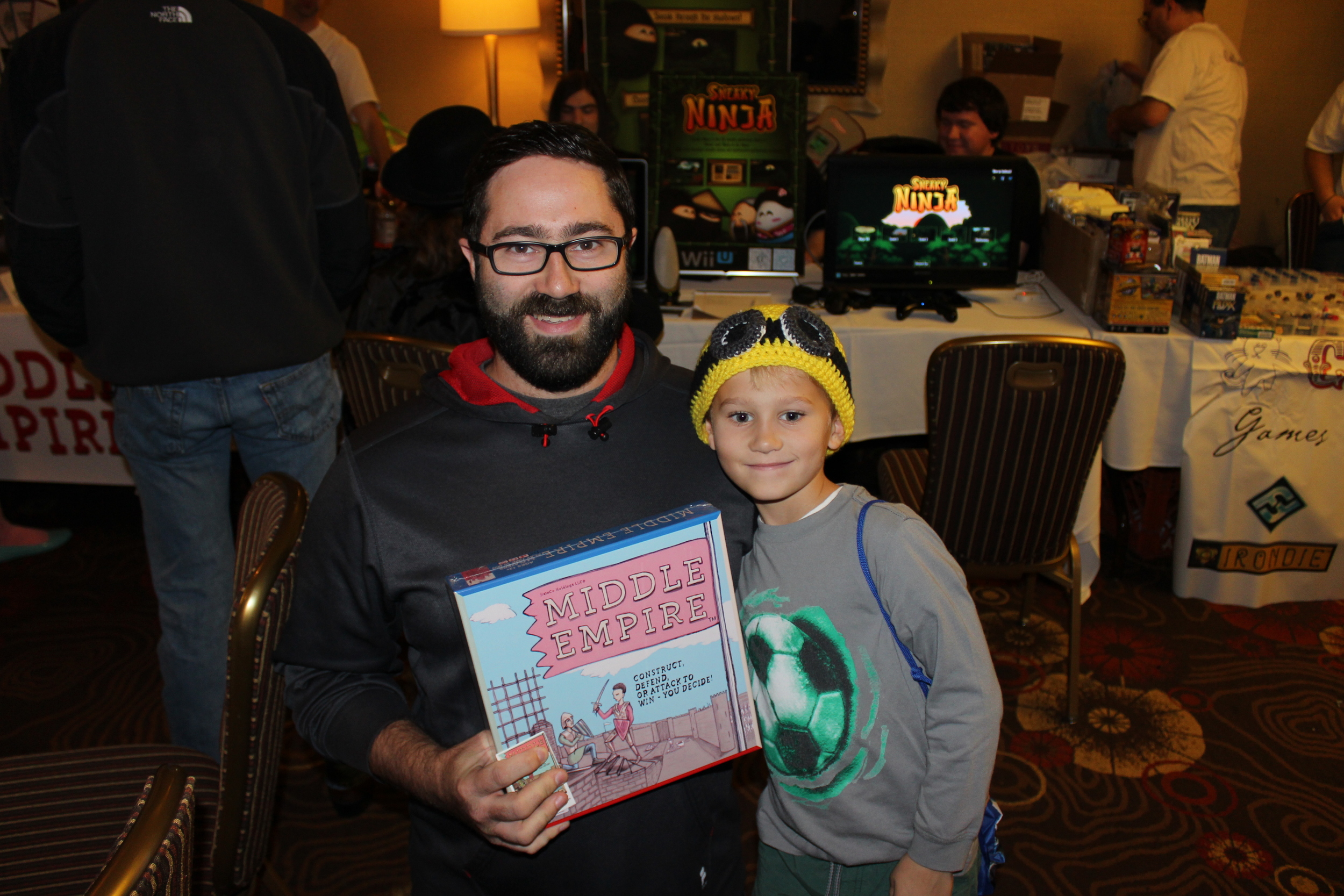 Bobby (left) and Mason pick up a brand new board game called Middle Empire.