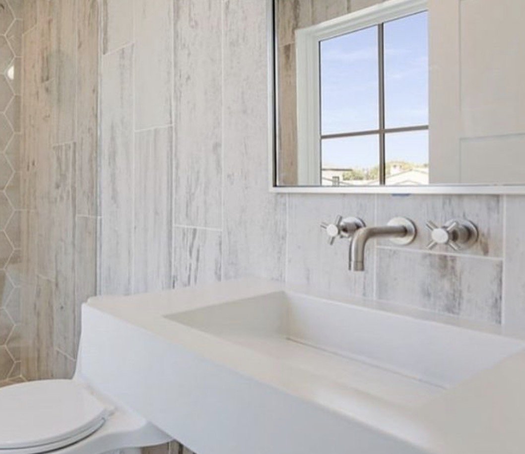 Handmade concrete ramp sink installed in a modern luxury bathroom, highlighting sleek design and minimalist style
