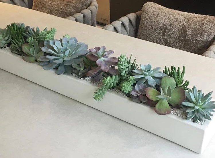 36-inch white concrete planter centerpiece on a white dining room table, showcasing modern sculptural form