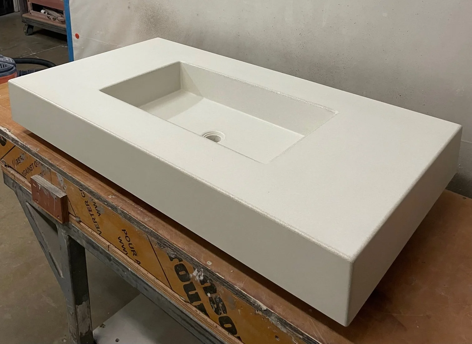 Top view of white farmhouse concrete sink, single bowl, handmade architectural concrete