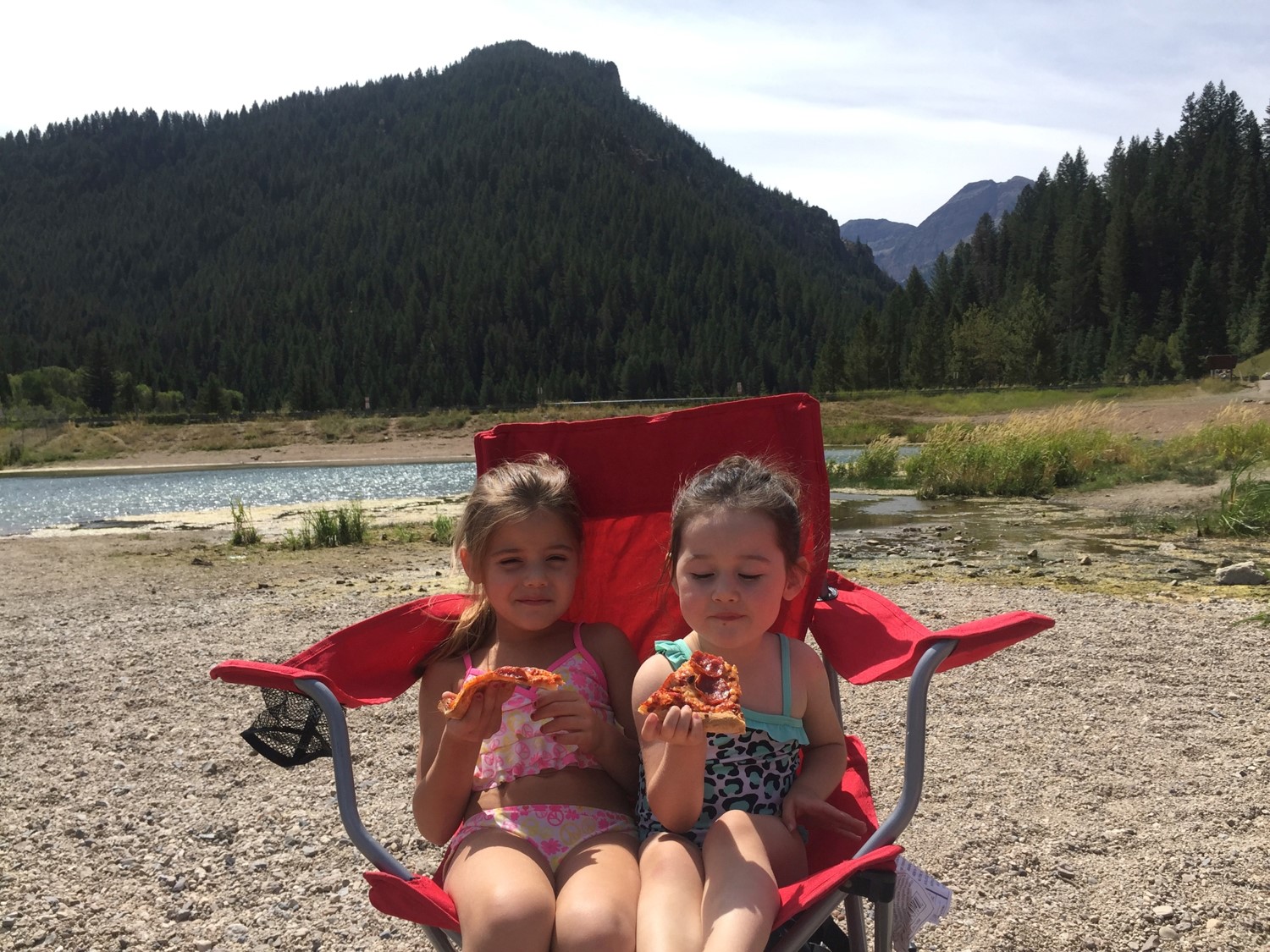     
 
      Lolah and Kaylie Palma taking a break from playing by eating pizza at Tibble Fork Lake Uinta National Forest. 