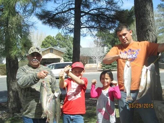 Lupe (left), grandkids Angelo and Naomi, and son Angel (right)