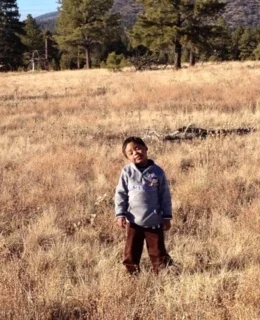 Liz's son Demetrius on a hike in the forest