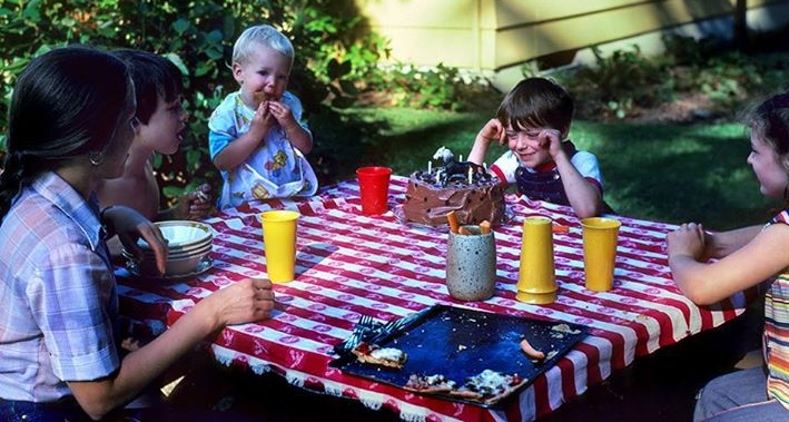 Family birthday party for Caleb on the lawn. Note little Ezra standing.