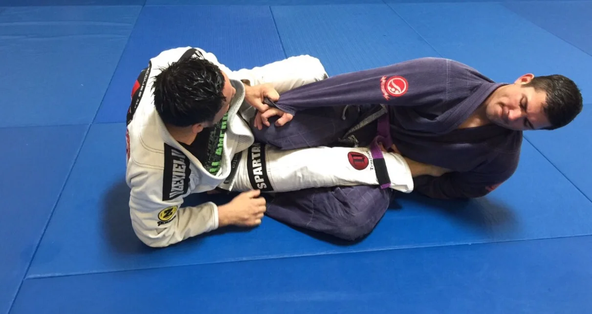 Sit up, pull your elbow to the outside of your rib cage, and clamp down. 