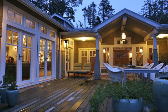 Back of house with covered back porch and rooms opening onto a huge entertaining deck.