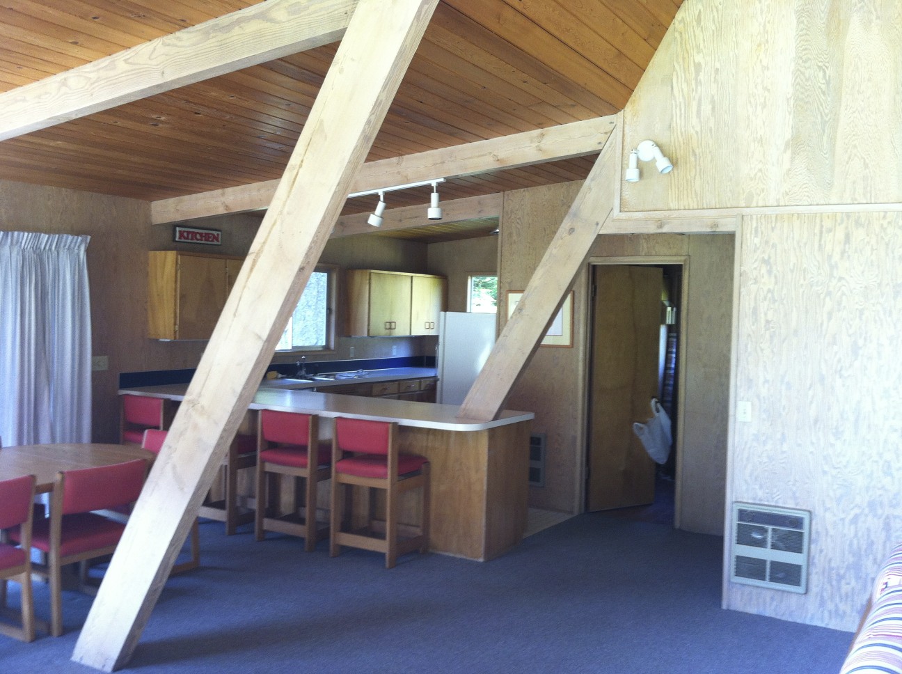 The kitchen was recesses behind the Aframe's roof beams
