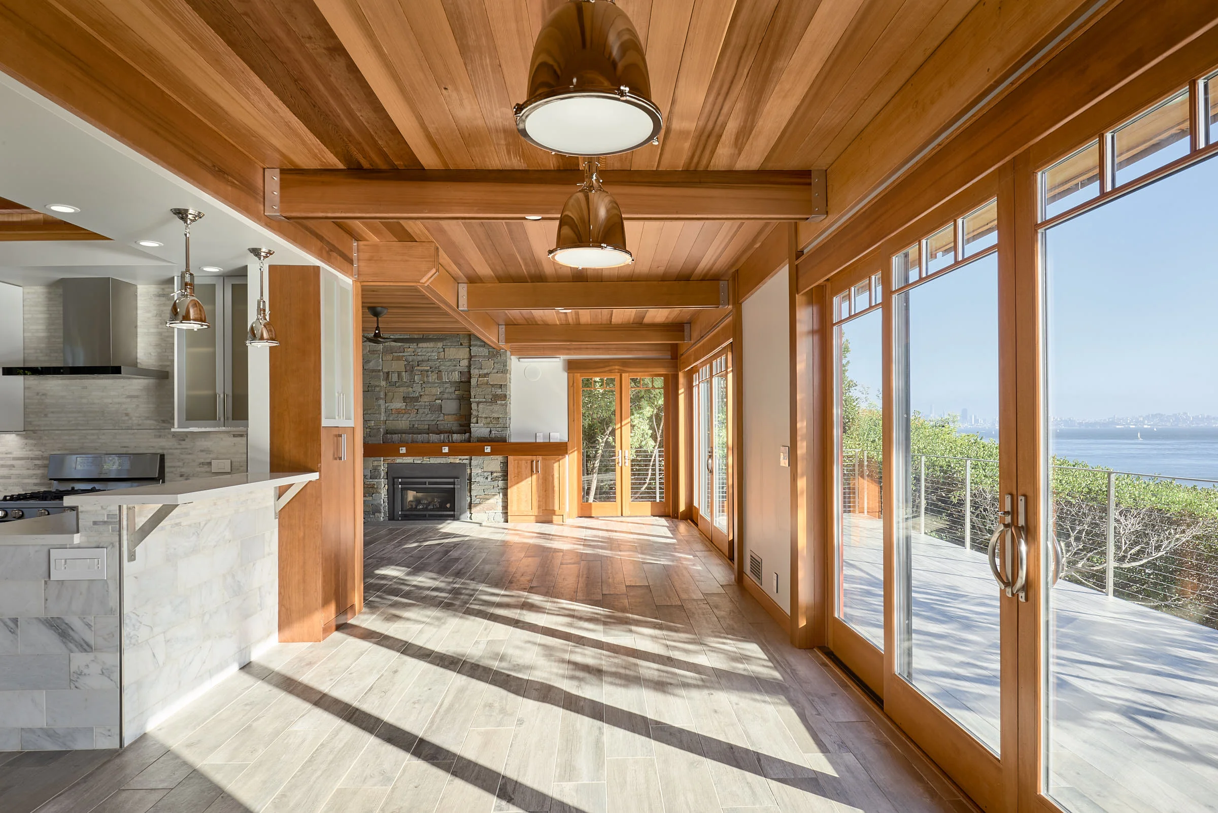 Now you can see the view from the kitchen is pretty spectacular. Porcelain tile Floors throughout continue onto the deck.