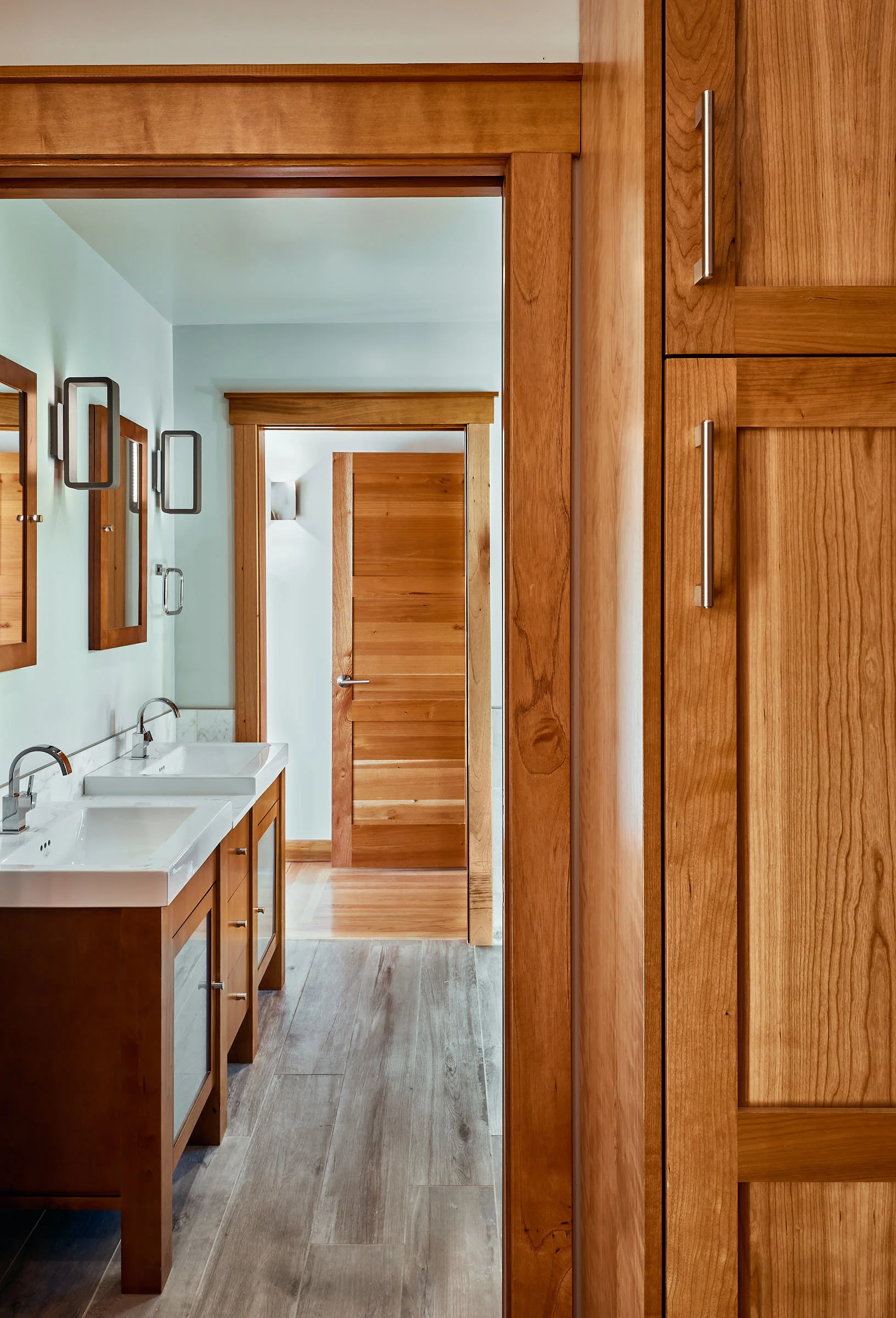 The warmth of the Spanish Cedar doors and cabinets, accent the Grey Porcelain Tiles in this Master Bathroom.