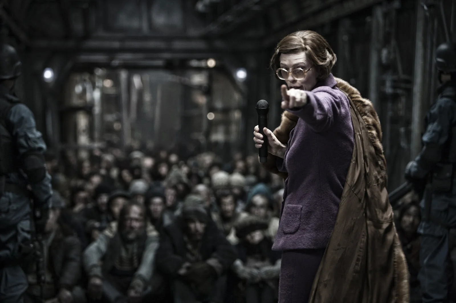 Mojo Film ; Opus Pictures/via rogerebert.com - 2013's Snowpiercer also takes place years after the apocalyptic event, which makes it easier for the film to explore societal issues alongside survival issues. Pictured here is Tilda Swinton as Mason.
