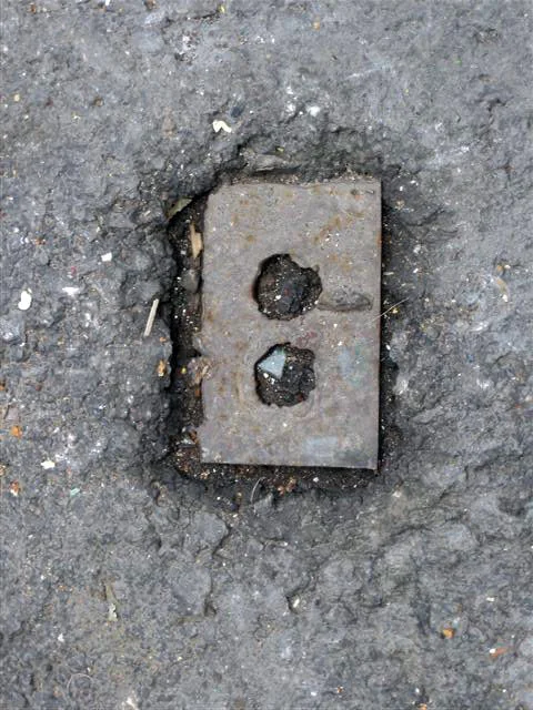 Wall plate into the cement (Downtown, Mexico City), 2008. From the series "Found Objects".