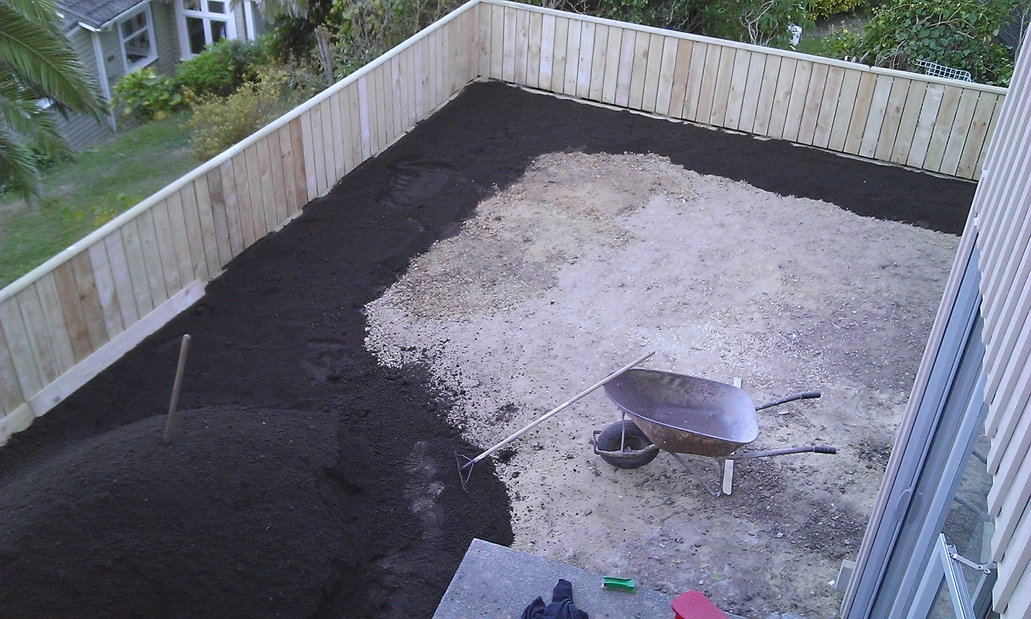  4.3 Fence built at top of retaining wall preparation for lawn underway 