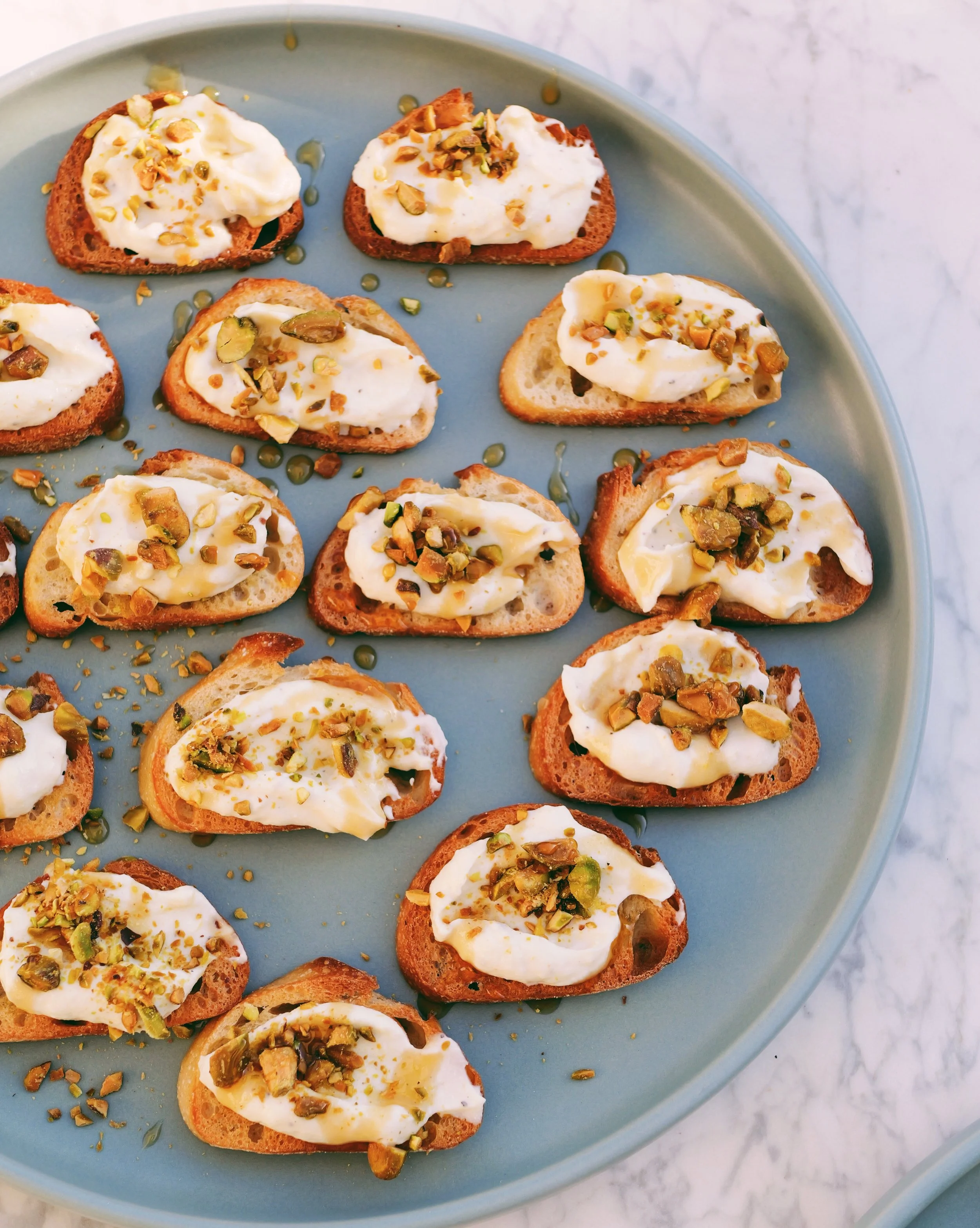 Whipped Ricotta Crostini with Pistachios + Hot Honey
