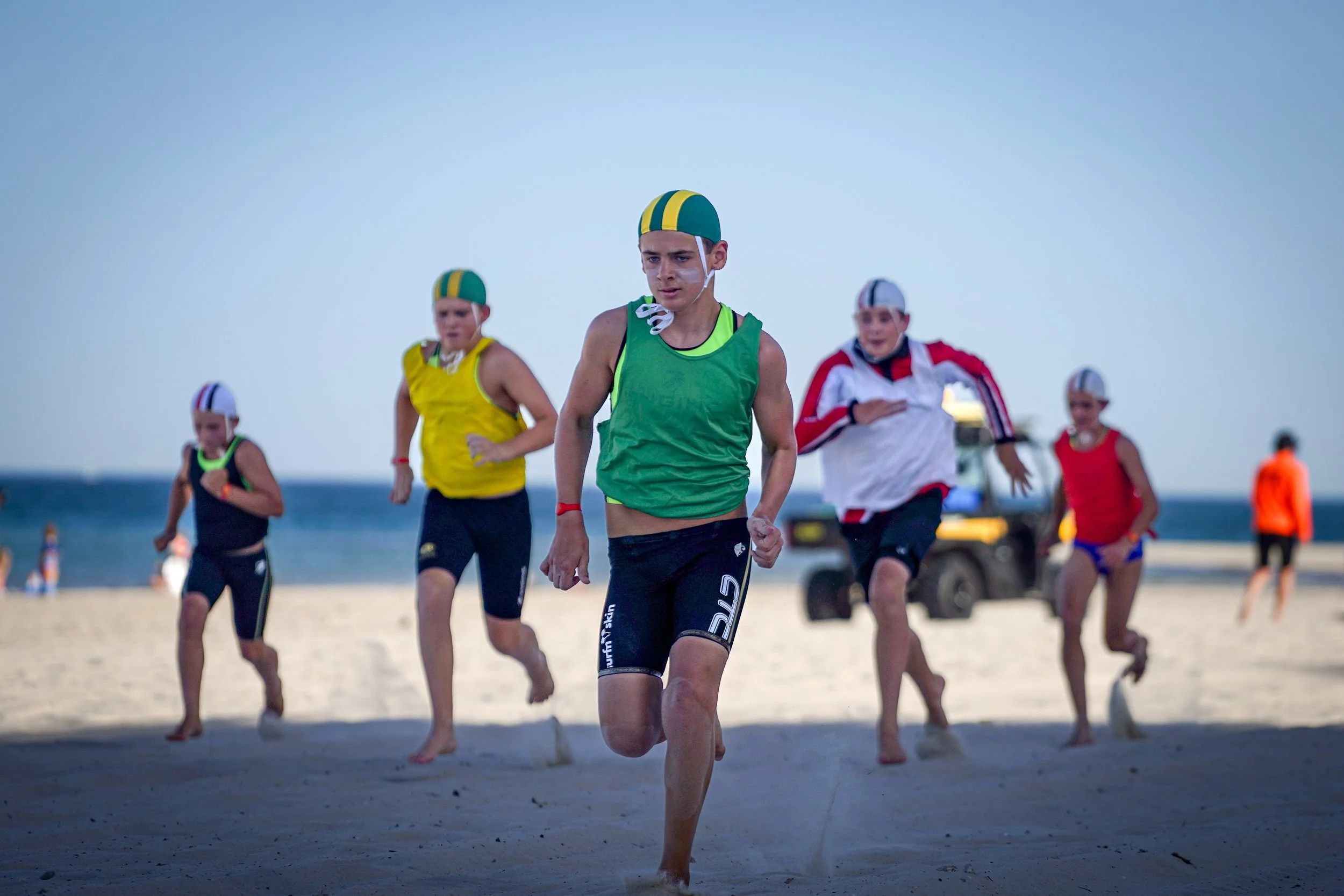Surf lifesaving athletes competing in a beach distance run