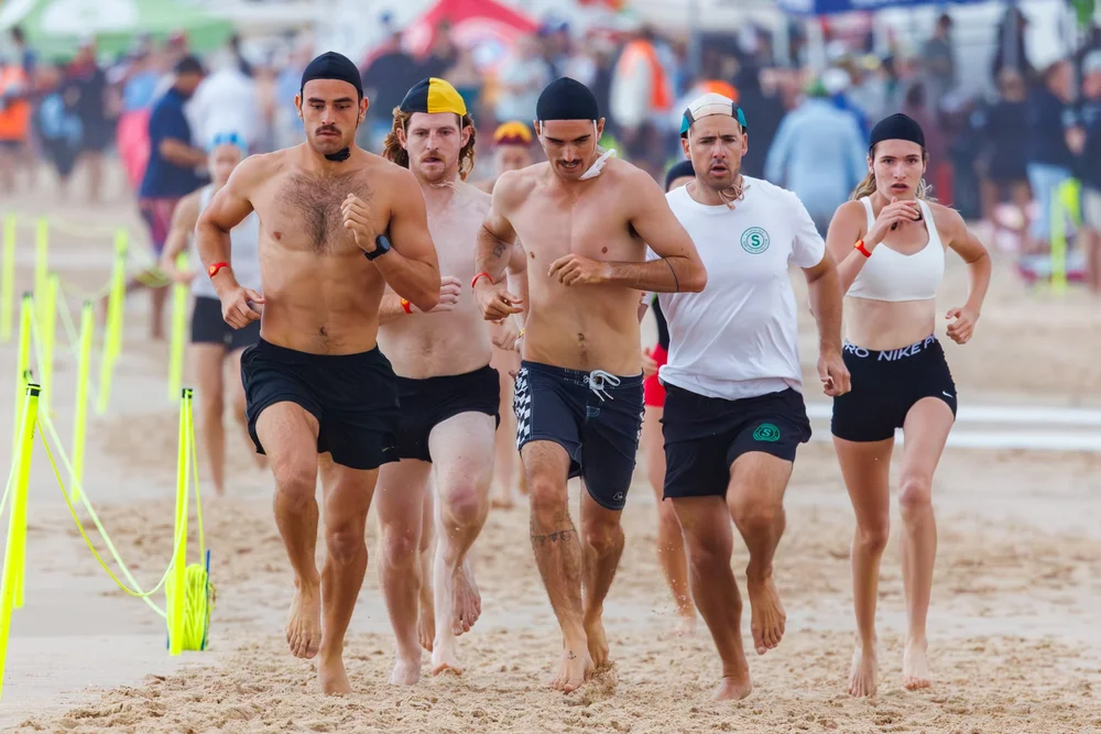 Surf lifesaving athletes competing in a beach distance run