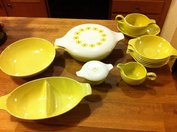 Taylor Smith & Taylor "Pebbleford" designed by John Gilkes. Not only are the shapes awesome, the daisy lids seem to be harder to find than the solids! These could have been a grocery store promo where you could earn pieces with what you spent on groceries. Mine are yellow, but there are also mint green, light blue and pink pieces available. 
