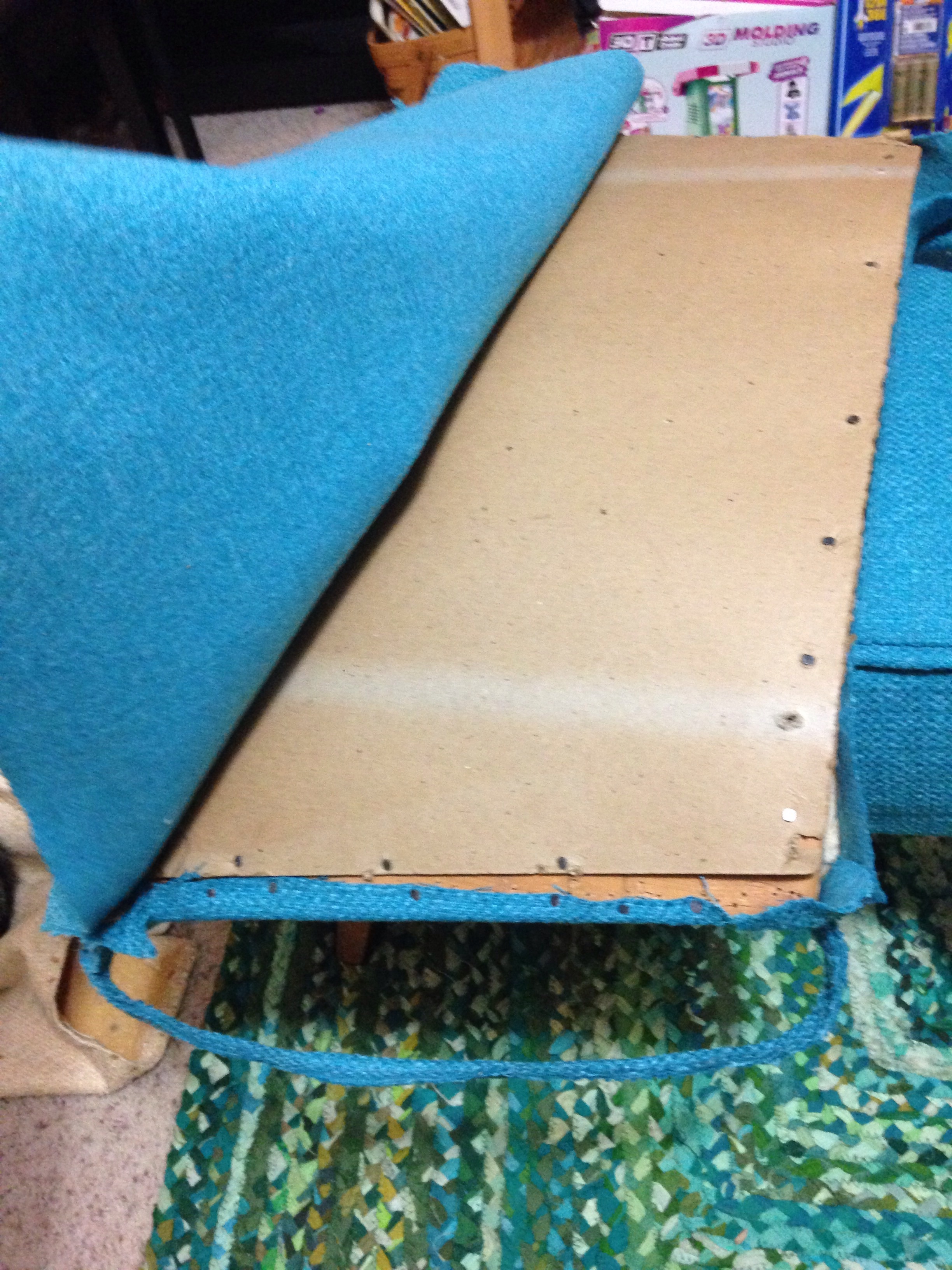 Cardboard backer is reinstalled then covered.