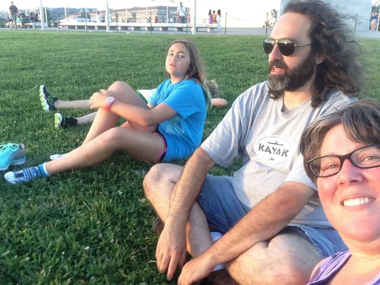 Resting at sunset on the lawn by the Washington Memorial.