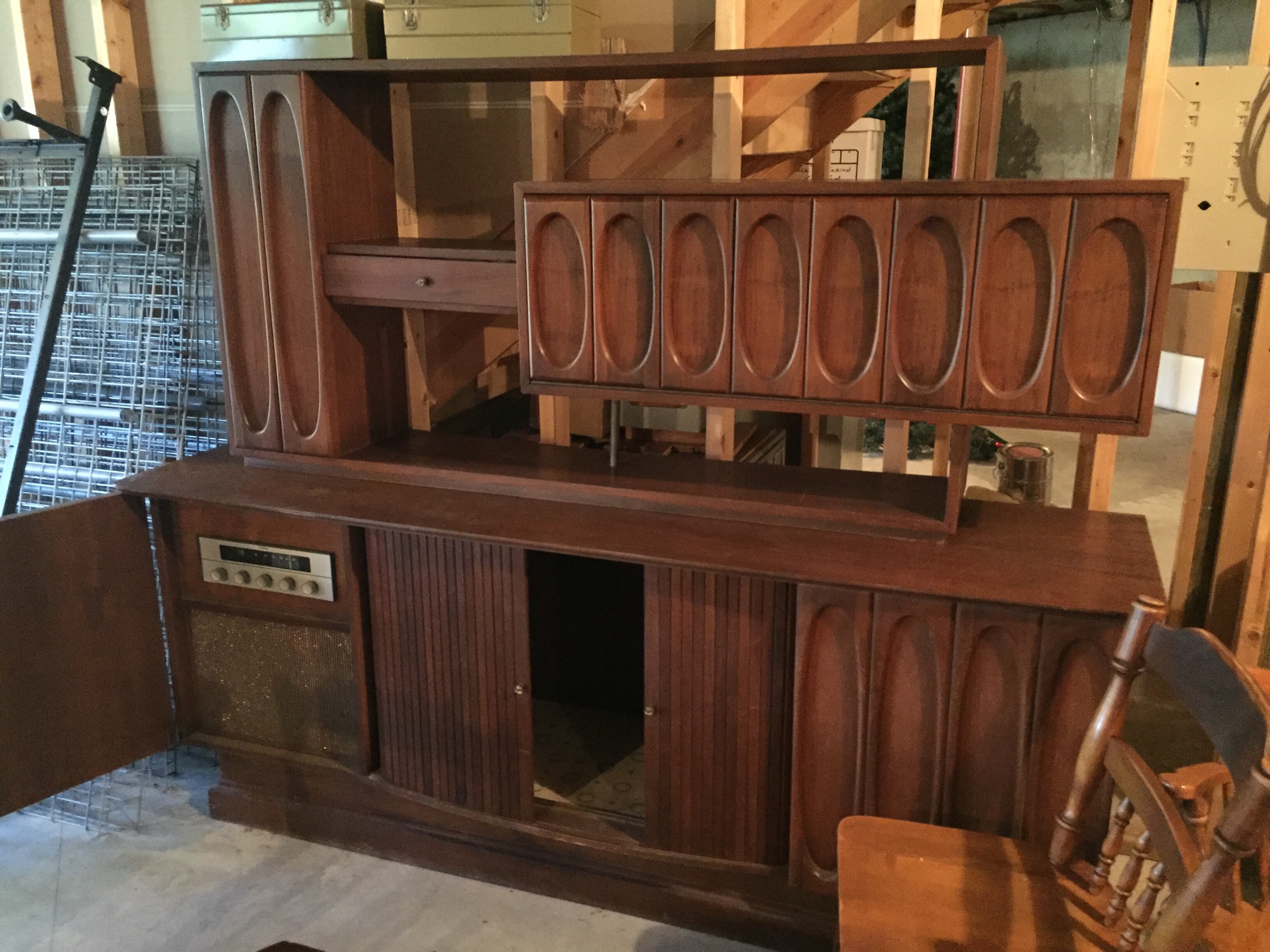 Amazing Walnut custom entertainment unit. This features built in speakers and receiver, pUll out for turntAble, tambour doors. The top cabinet has a bar area! I can’t wait to get it home and cleaned up., test the audio equipmenT and report back. It is a 2 pc unit.