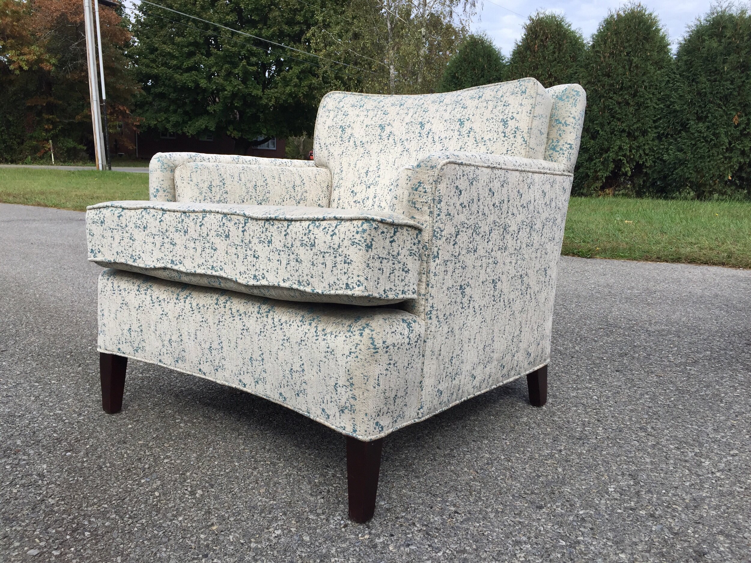Handsome from every side! Gorgeous designer fabric in white velvety tweed and high sheen teal or peacock overstitching in a random abstract allows thE light to dance off beautifully. I never was one for white furniture but the touch of blue is faNtastic and it adds light to a soace instead of draB. I am thinking about ordering more for my pearsall couch i love it so much!