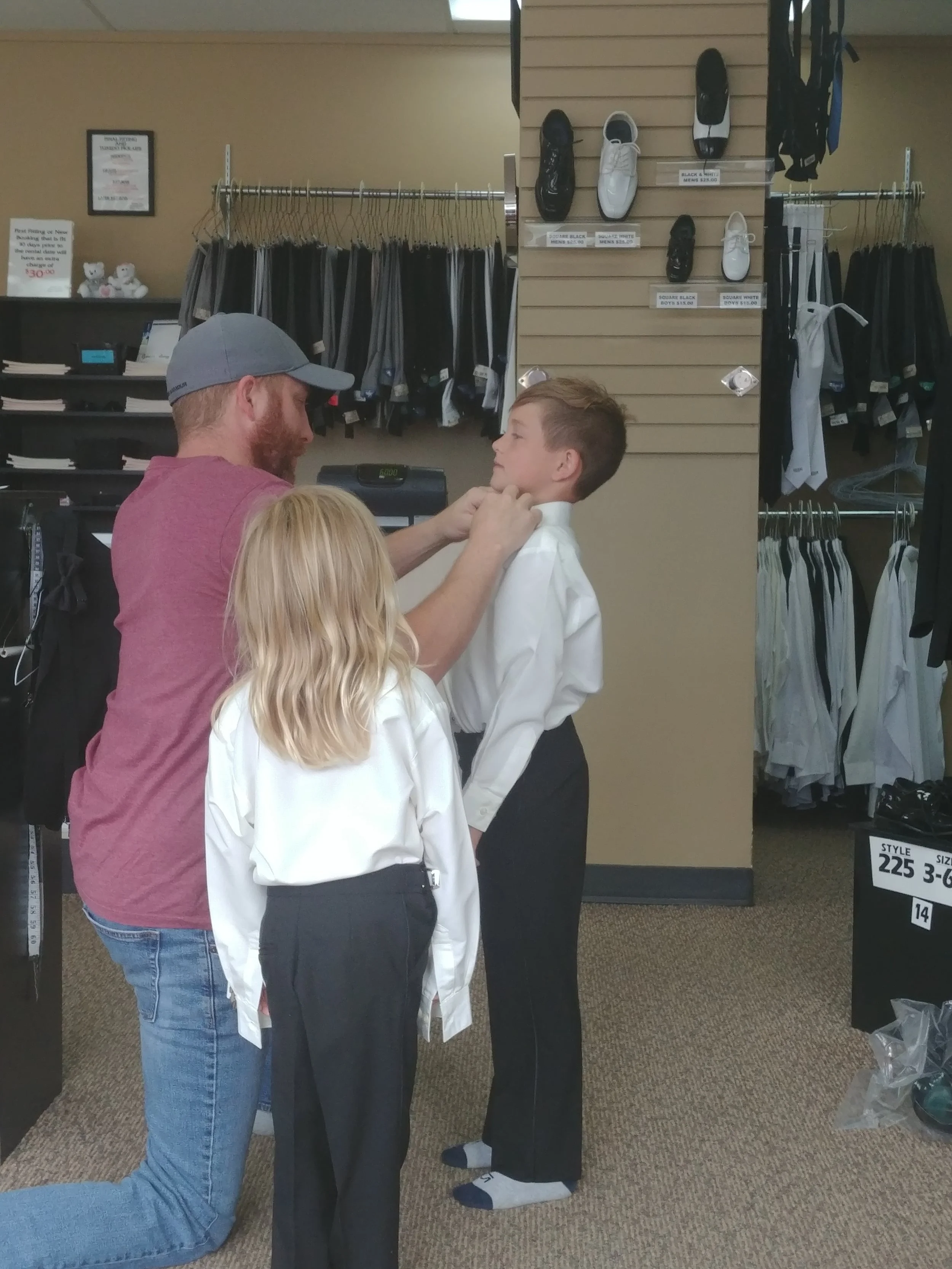 The boys getting fitted for their tuxes.