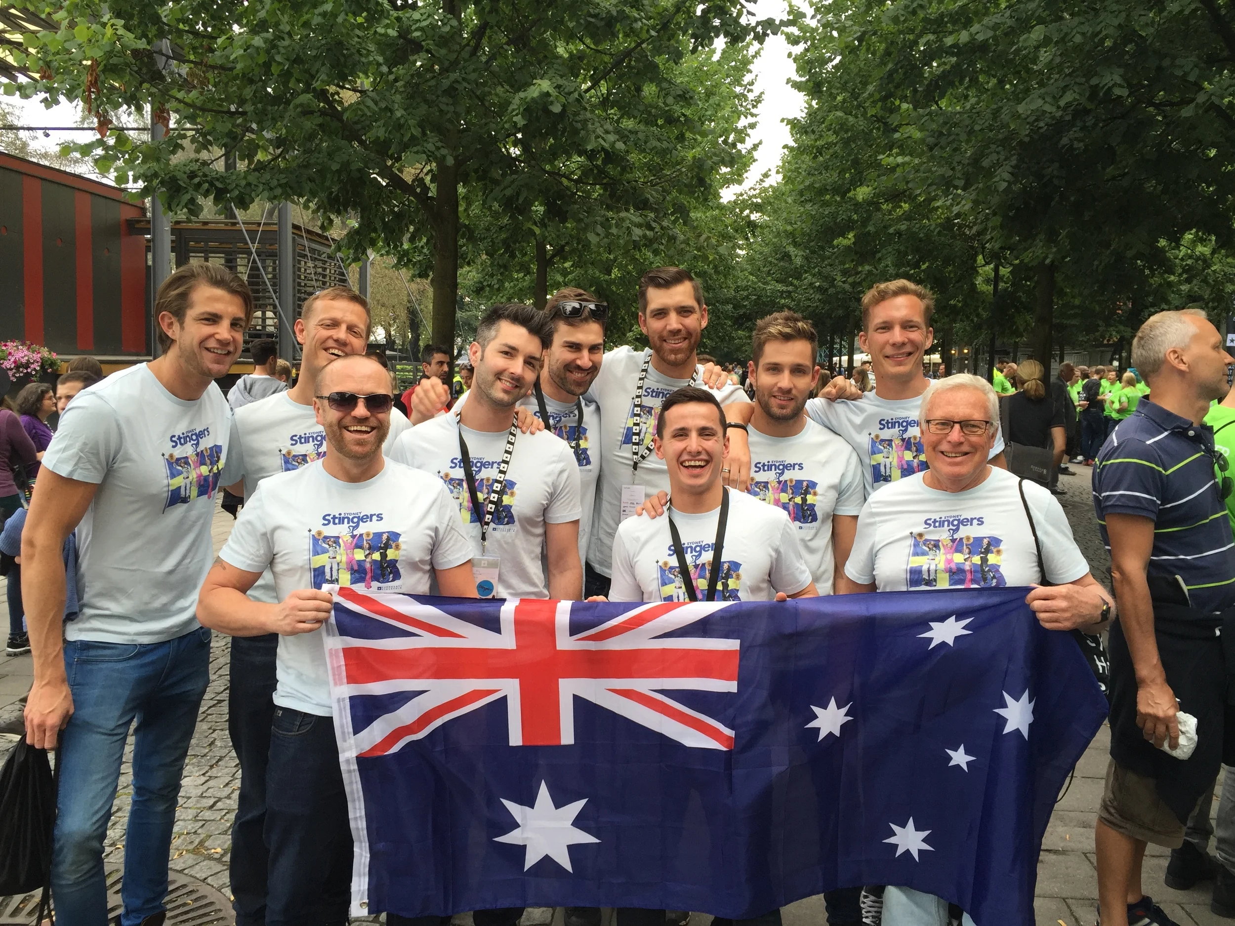Sydney Stingers team holding Australian flag at international event